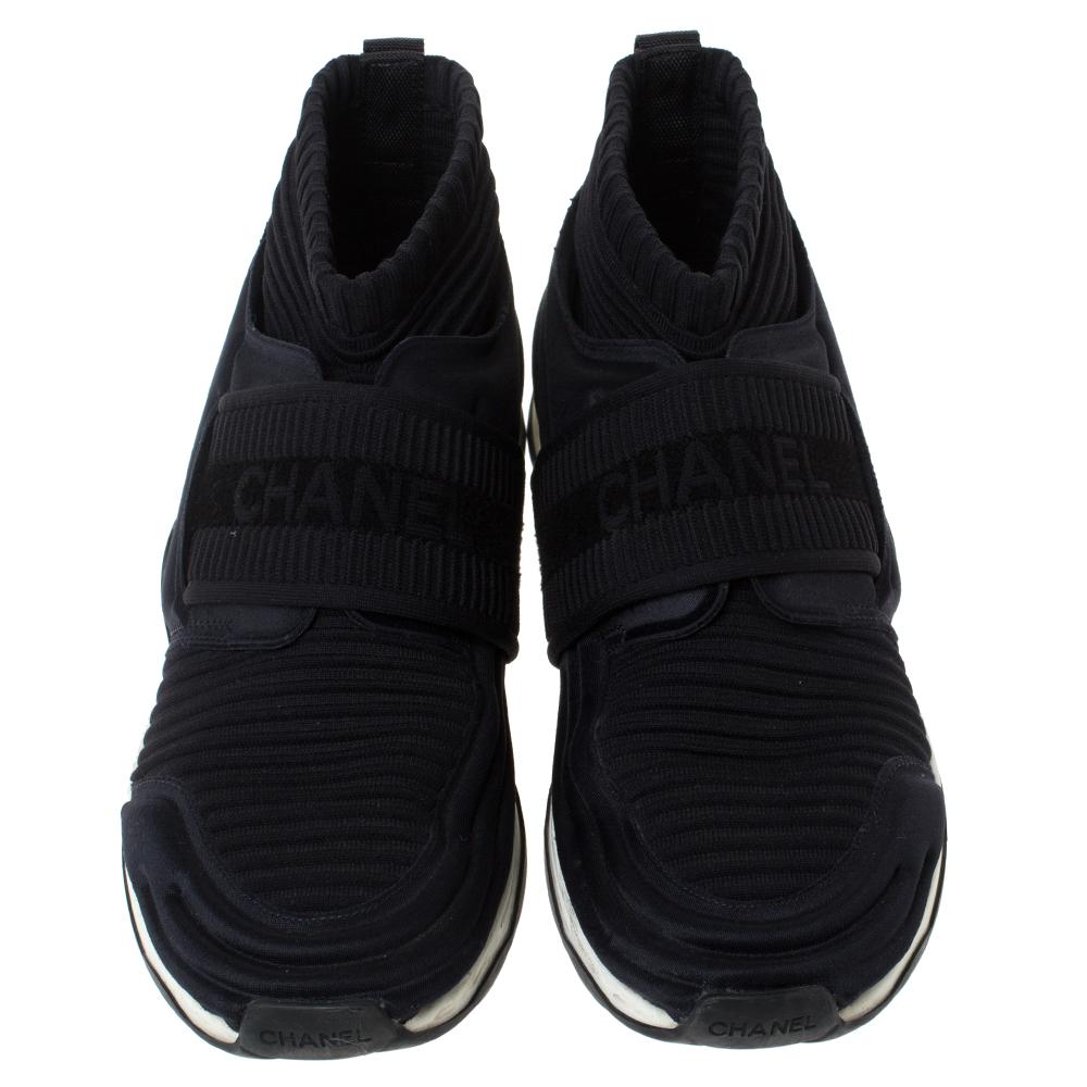 Designed using cotton knit fabric, these sneakers by Chanel are fashioned in a sock style. They bring round toes, logo-detailed strap on the vamps and the brand logo on the counters. The sneakers are set on rubber soles for all-day comfort.

