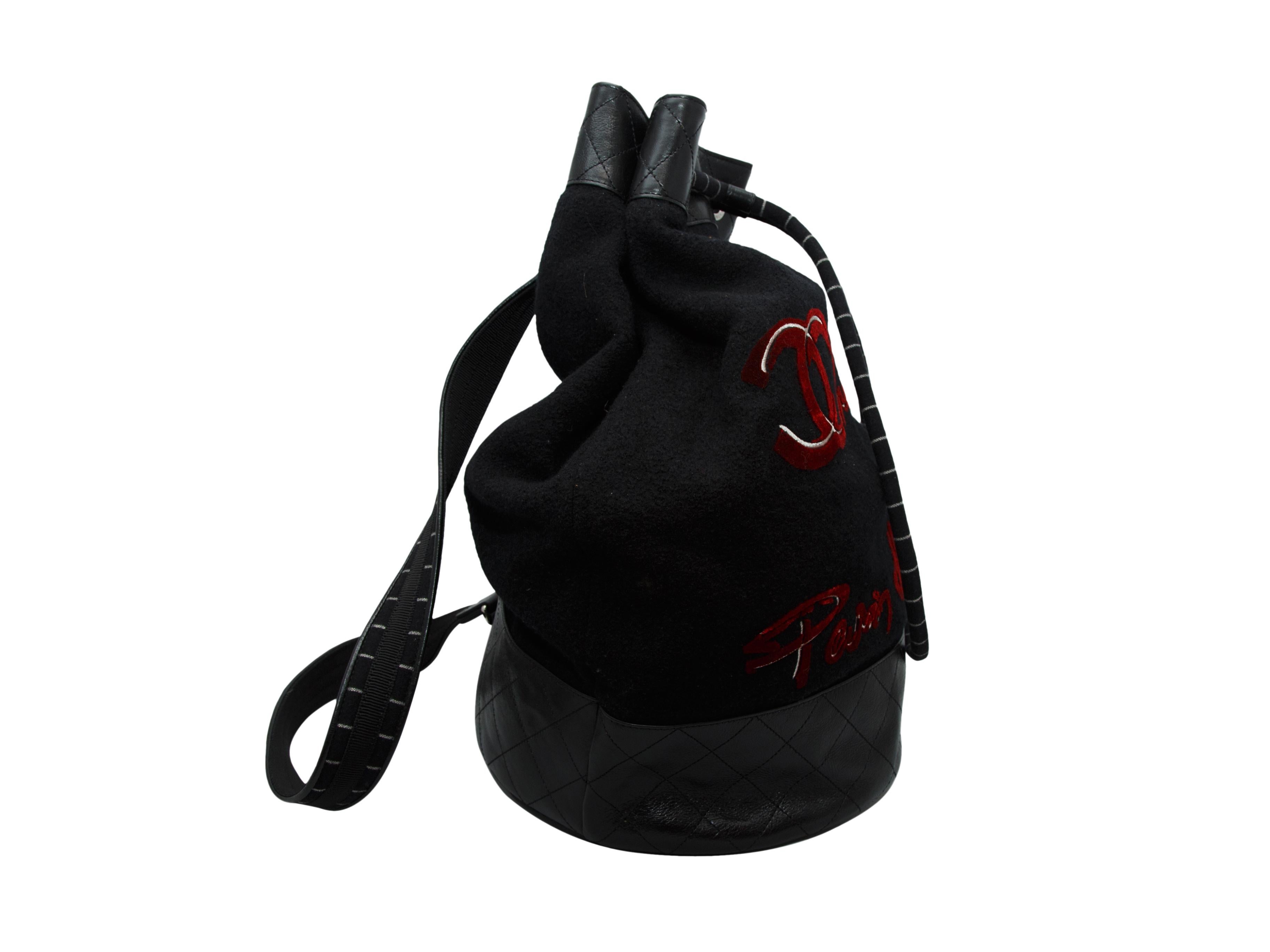 Product details: Black canvas and leather backpack by Chanel. From the Fall 2018 Collection. Black and red embroidery at exterior. Silver-tone hardware. 16