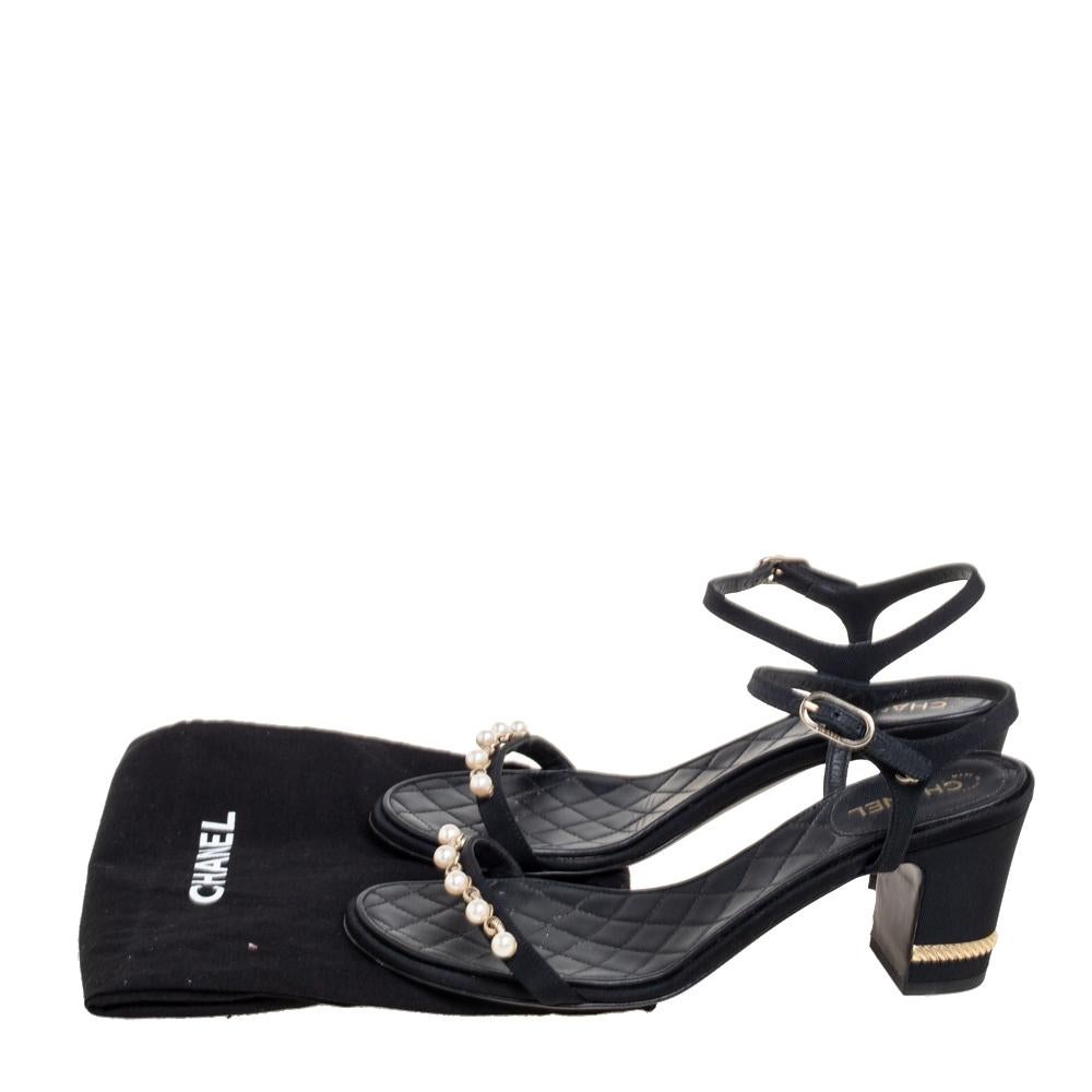 A creation worth the investment, these Chanel sandals exemplify the brand's supreme mastery in shoemaking. Created from fabric on the exterior, the design is accentuated with gold-tone metal accents on heels and faux pearl embellishments on the