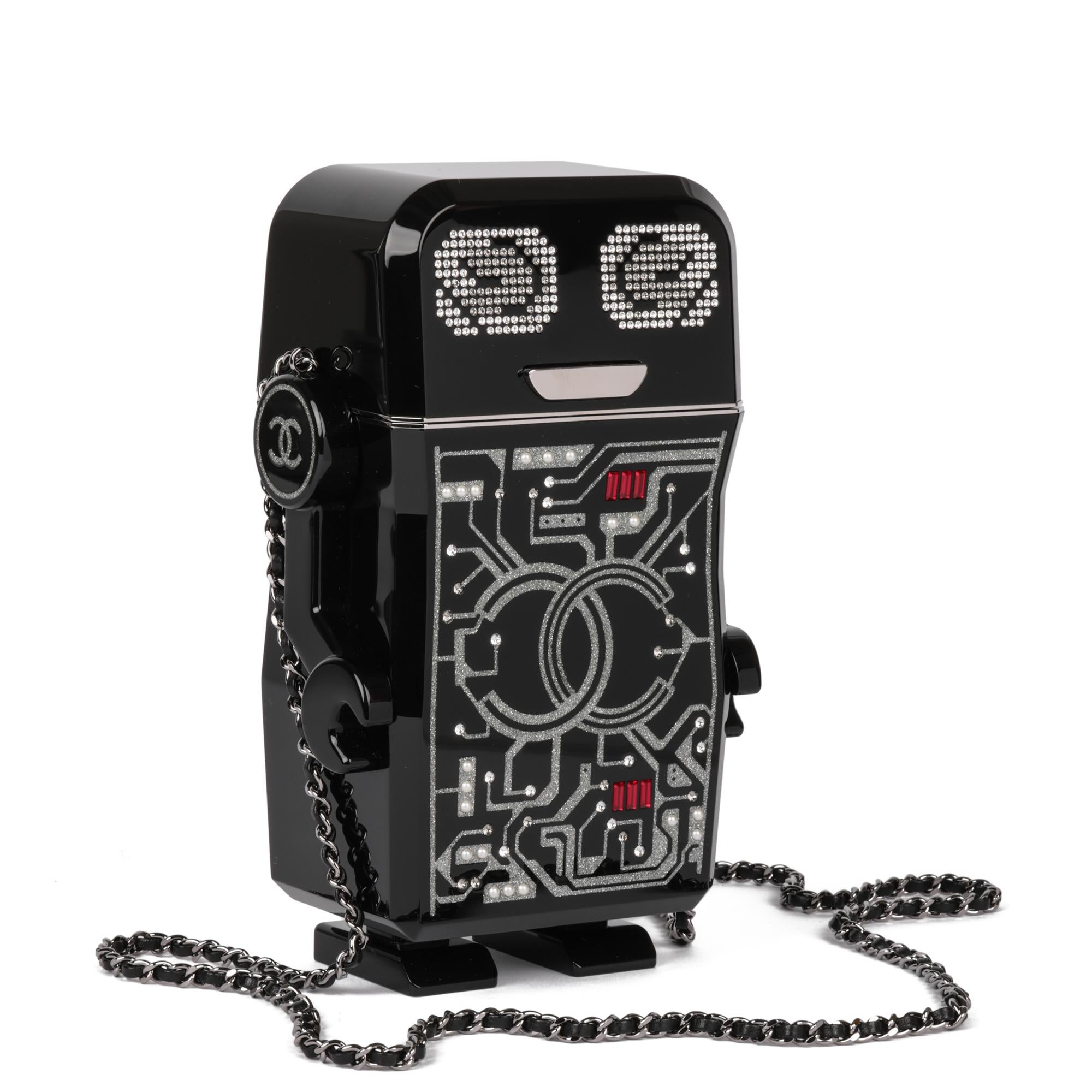 CHANEL
Black Glitter Plexiglass Robot Minaudiere

Xupes Reference: CB879
Serial Number: 24244461
Age (Circa): 2017
Accompanied By: Chanel Dust Cover, Box, Authenticity Card, Care Booklet
Authenticity Details: Authenticity Card, Serial Sticker (Made