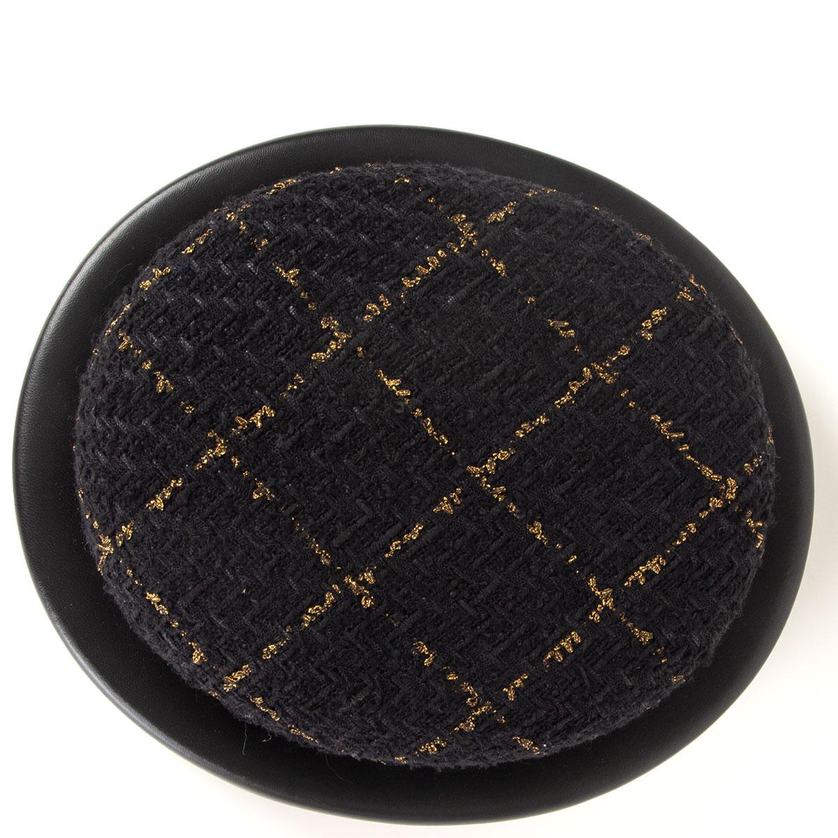 Chanel tweed riding hat in black and gold polyamide (16%), viscose (16%), wool (12%), cotton (5%), acrylic (5%), mohair (5%) and polyester (1%). Trim is made of lambskin (100%). Lined in black rabbit-hair (100%) Leather straps on the side got cut