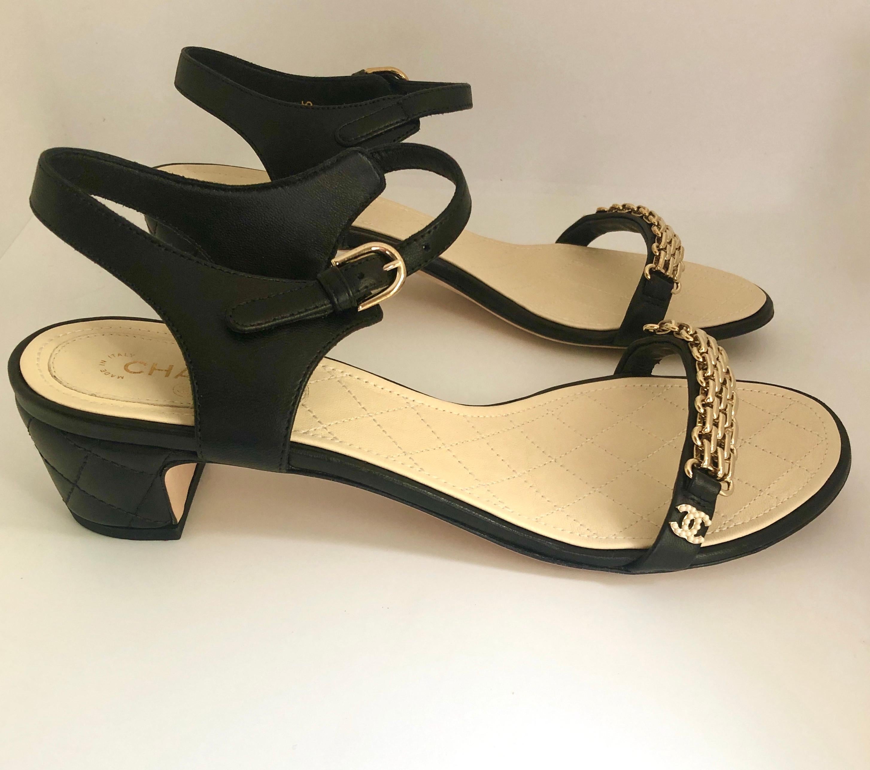 Offered is a pair of black Chanel signature quilted leather gold metal chain over leather strap sandal with 2