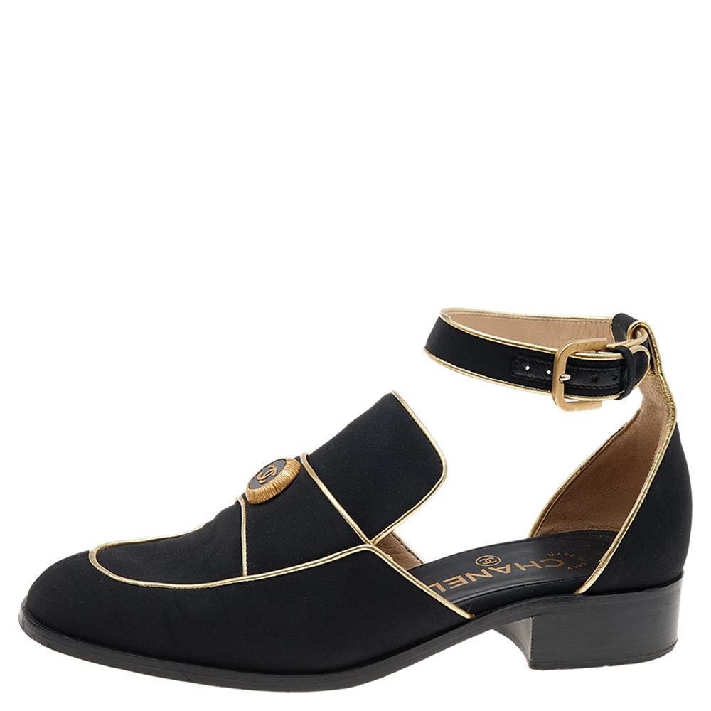 Comfort meets fashion with these Chanel loafer sandals. They're sewn using black fabric and elevated with gold leather, simple buckle strap closure, and low heels

Includes: Original Box, Info Booklet