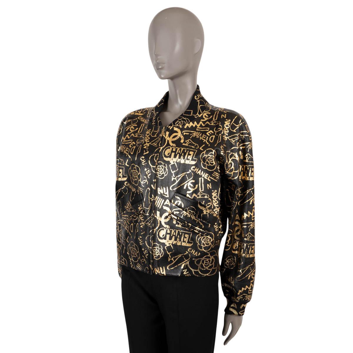 100% authentic Chanel bomber jacket in black lambskin leather (100%) with metallic gold graffiti print. Features two zip pockets at the waist, rib-knit neck, hem and cuffs. Closes with a zipper on the front and is lined in silk (100%). Has been worn