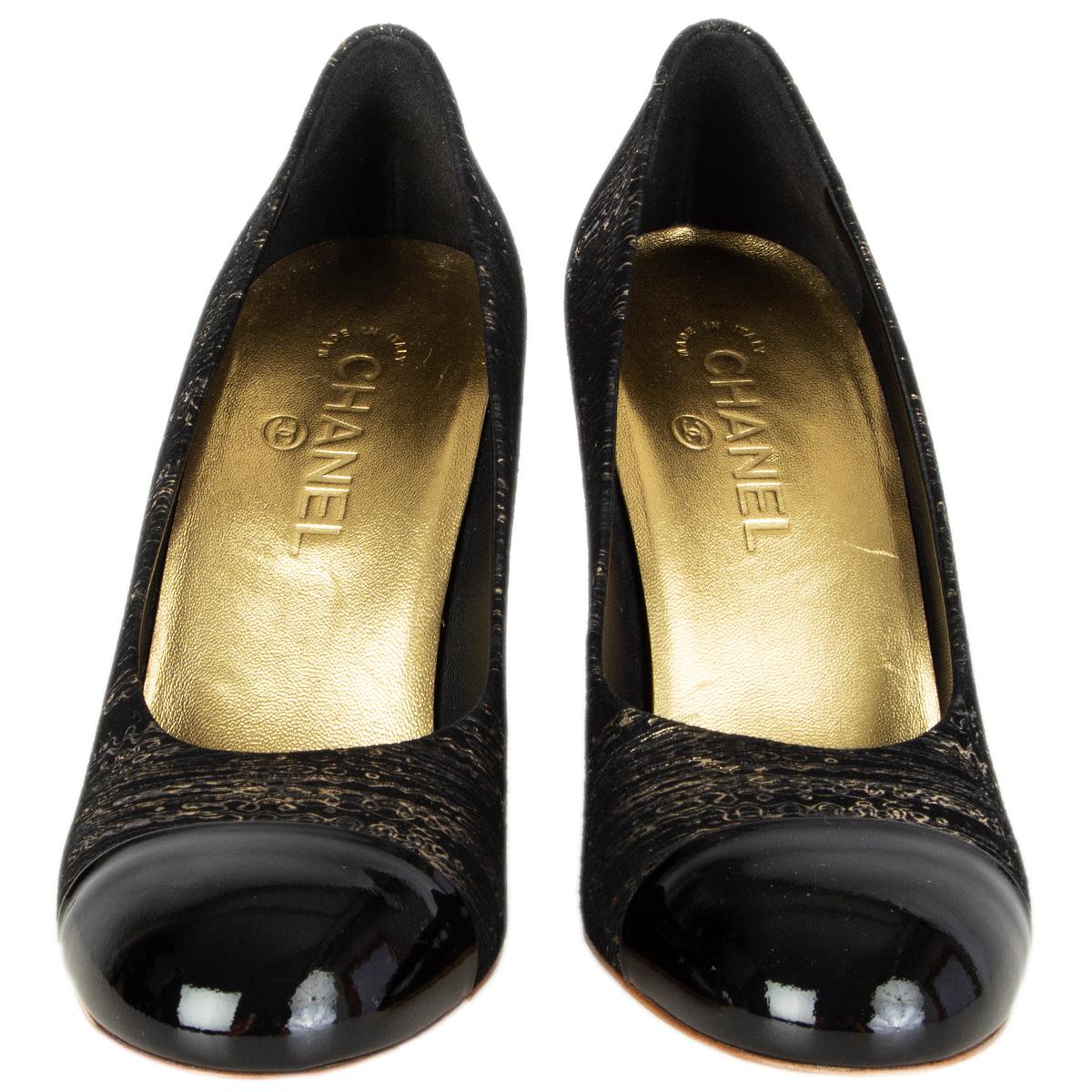 100% authentic Chanel pumps in black and gold-tone printed suede featuring black patent leather tip and faux pearl embellished heel. Brand new. 

Measurements
Imprinted Size	39
Shoe Size	39
Inside Sole	25cm (9.8in)
Width	7.5cm (2.9in)
Heel	10cm