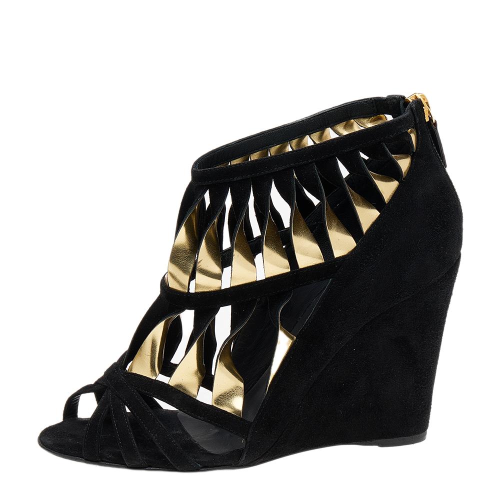 These sandals from Chanel will help you take every step with confidence, luxury, and style! They are crafted using black-gold suede and leather, which are embellished with strappy details. They showcase open toes, gold-tone hardware, and wedge