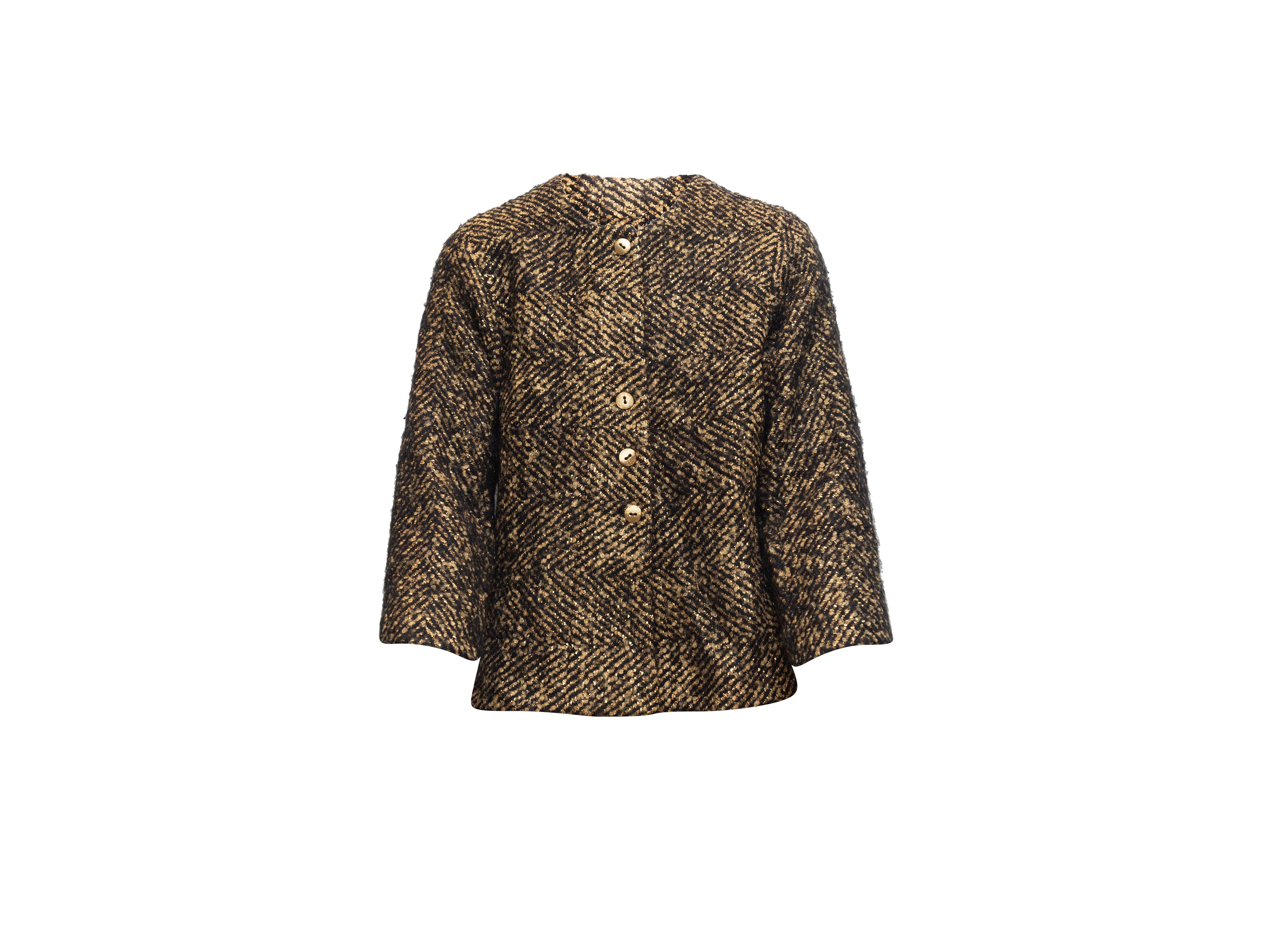 Product details: Black and gold wool tweed jacket by Chanel. Crew neck. Gold-tone button closures at center front. Designer size 44. 34