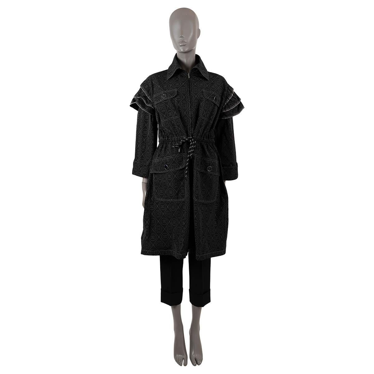 100% authentic Chanel parka in black polyester canvas (100%) with grey CC and Camellia print. Features layered shoulders, two flap pockets at the chest and two at the waist which close with black enamel CC buttons. Closes with a concealed double