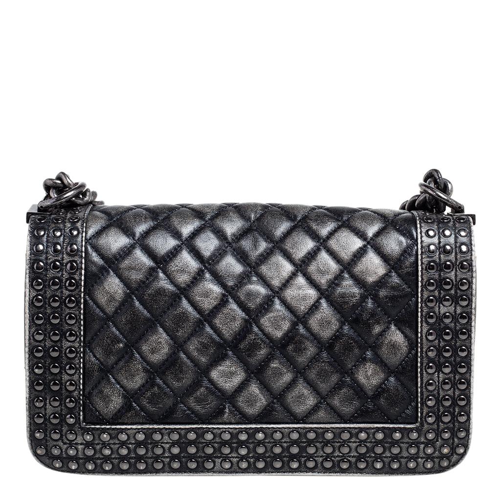 The Boy flap bag is an icon of Chanel's. This here is a version in black and grey quilted leather. It brings the signature label within the fabric interior and the iconic CC push lock on the flap. The piece has silver-tone hardware and a shoulder