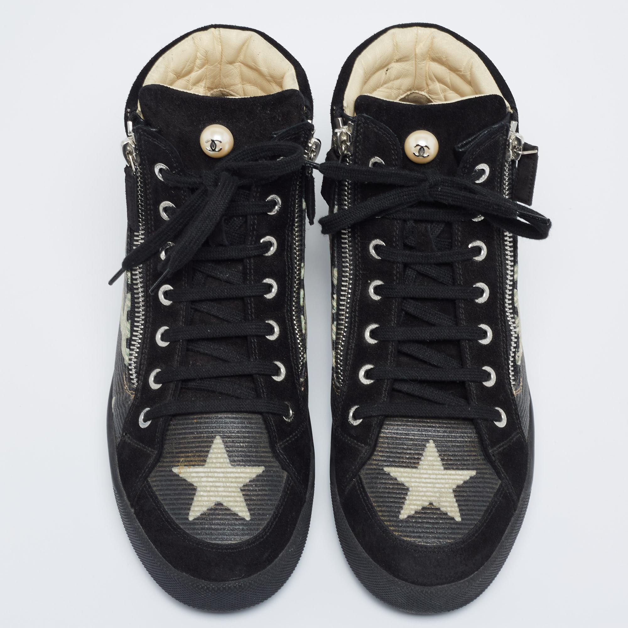 These high-top sneakers from Chanel are simply amazing. They have been crafted from suede and leather and exhibit round toes, lace-ups on the vamps, double zippers on the sides, and CC logo stitch detailing. Comfortable leather-lined insoles and