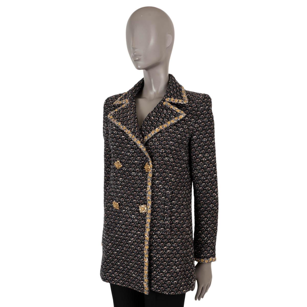 100% authentic Chanel tweed peacoat jacket in black, grey, white and orange tweed wool (69%), polyamide (20%) and cotton (11%). The design features four stone embellished gold-tone buttons, one on each cuff, gold lurex braided trim and two slit