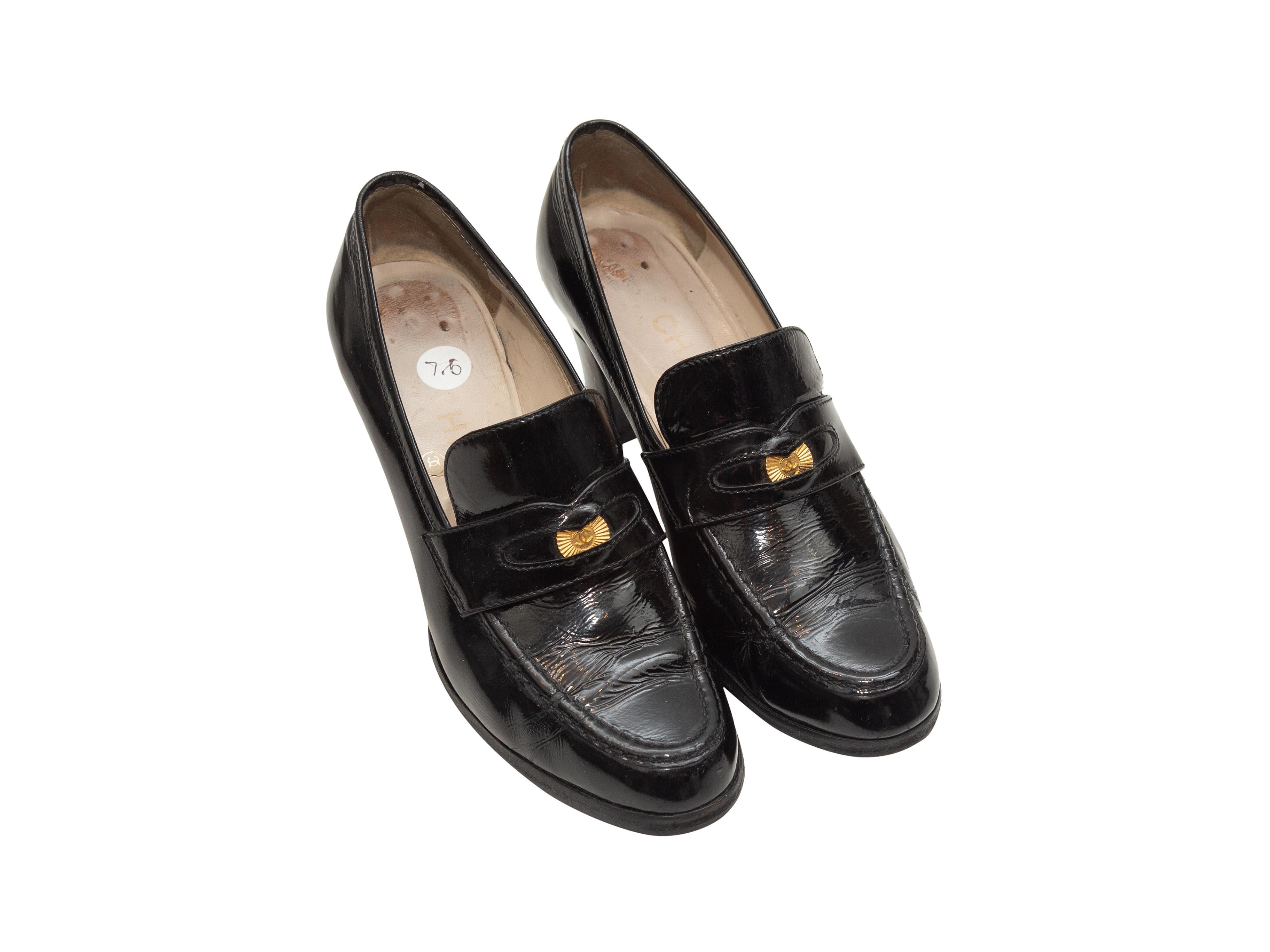 Product details: Vintage black patent leather heeled penny loafers by Chanel. Gold-tone metal CC accents at tops. Designer size 37.5. 2.5