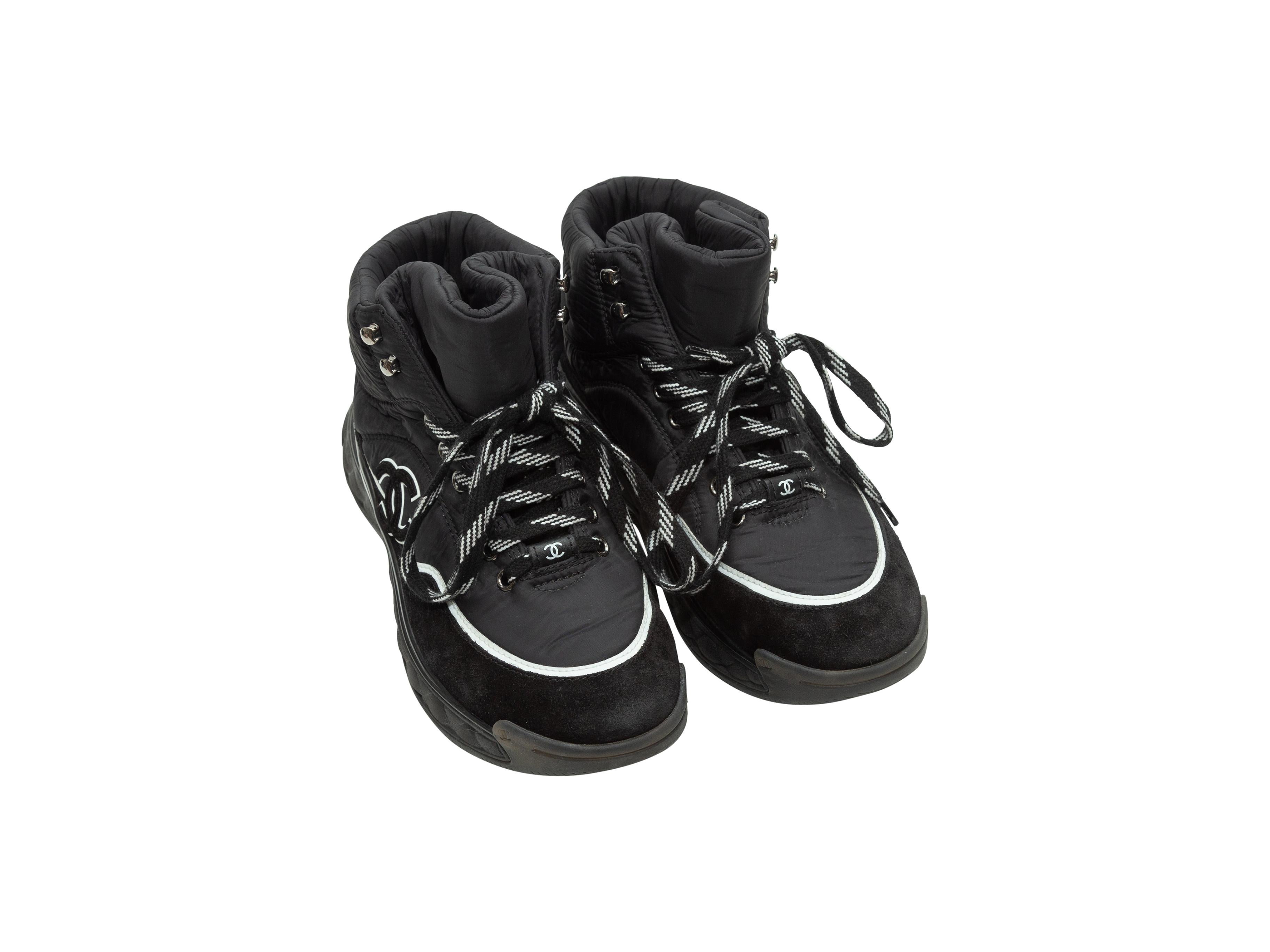 Product details: Black high-top platform sneakers by Chanel. Contrast white trim. Suede and nylon panels throughout. Lace-up tie closures at tops. Designer size 38.5. 1.5