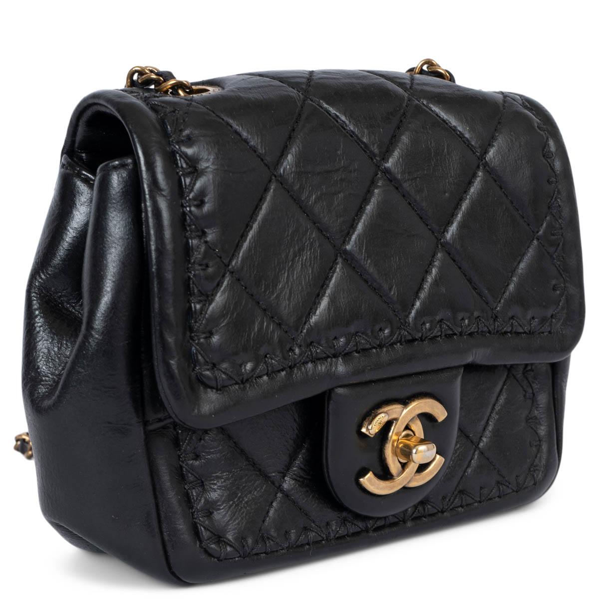 100% authentic Chanel quilted mini shoulder bag in black aged calfskin featuring antique gold-tone hardware and tonal stitching details. The design comes with a classic CC turn-lock and the bag is line in burgundy grosgrain with one slit pocket