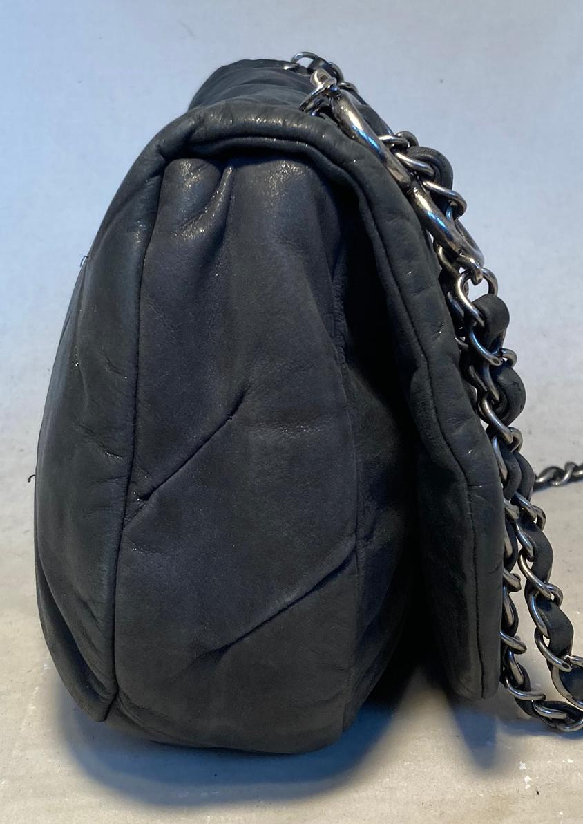 Chanel Black Iridescent Calfskin Glint Crossbody Classic Flap in very good condition. Black shimmering soft pinched calfskin leather exterior trimmed with antiqued silver hardware and woven chain and leather shoulder strap. Front snap single flap