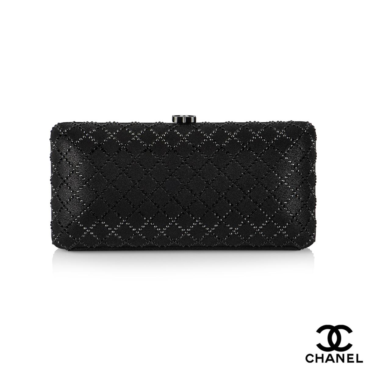 A stunning black lambskin Chanel crystal quilted clutch. This clutch is crafted of soft lambskin leather in black and features iridescent black crystals in a diamond pattern. The opening of the clutch is an iconic double 'C' logo made from metallic