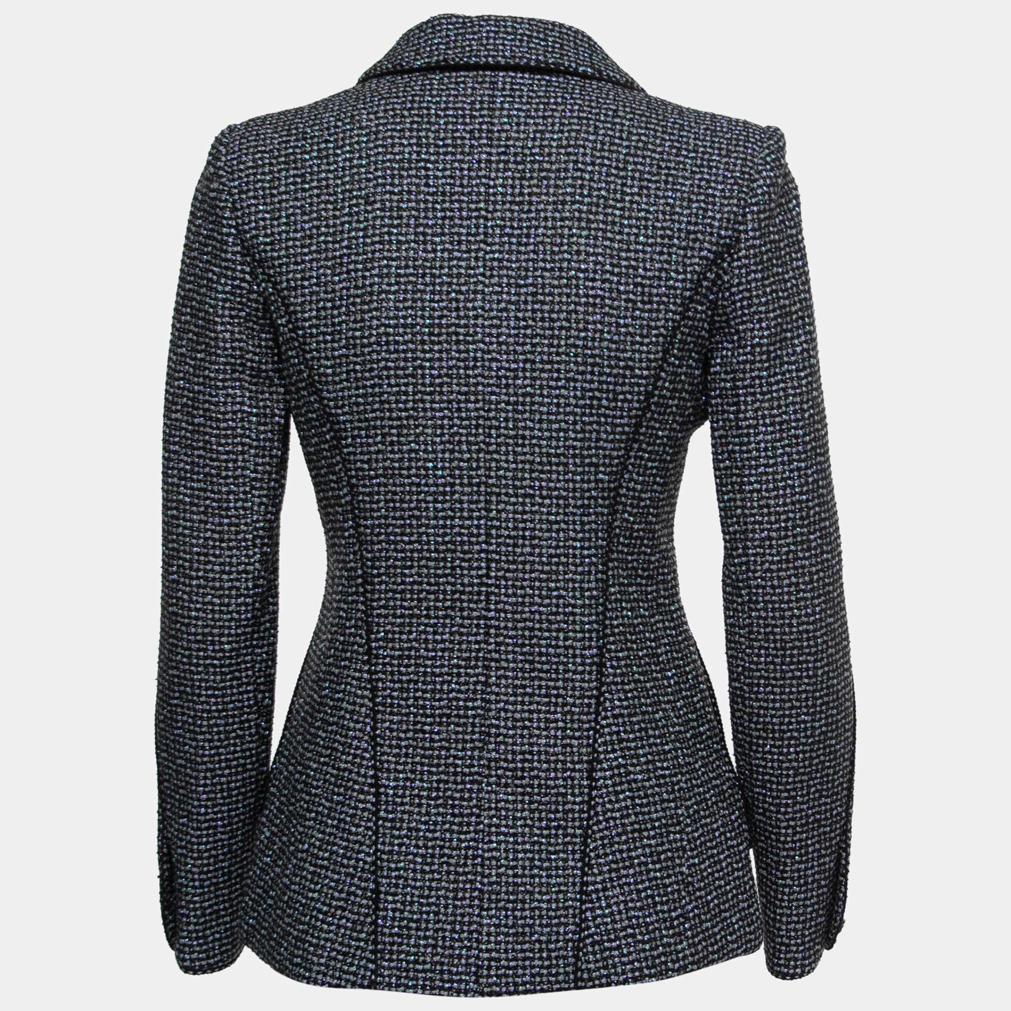 The Chanel tweed jacket exudes timeless elegance. Crafted from luxurious tweed fabric, this tailored jacket features a single-button closure, structured shoulders, and a classic collar. Its impeccable design showcases Chanel's signature