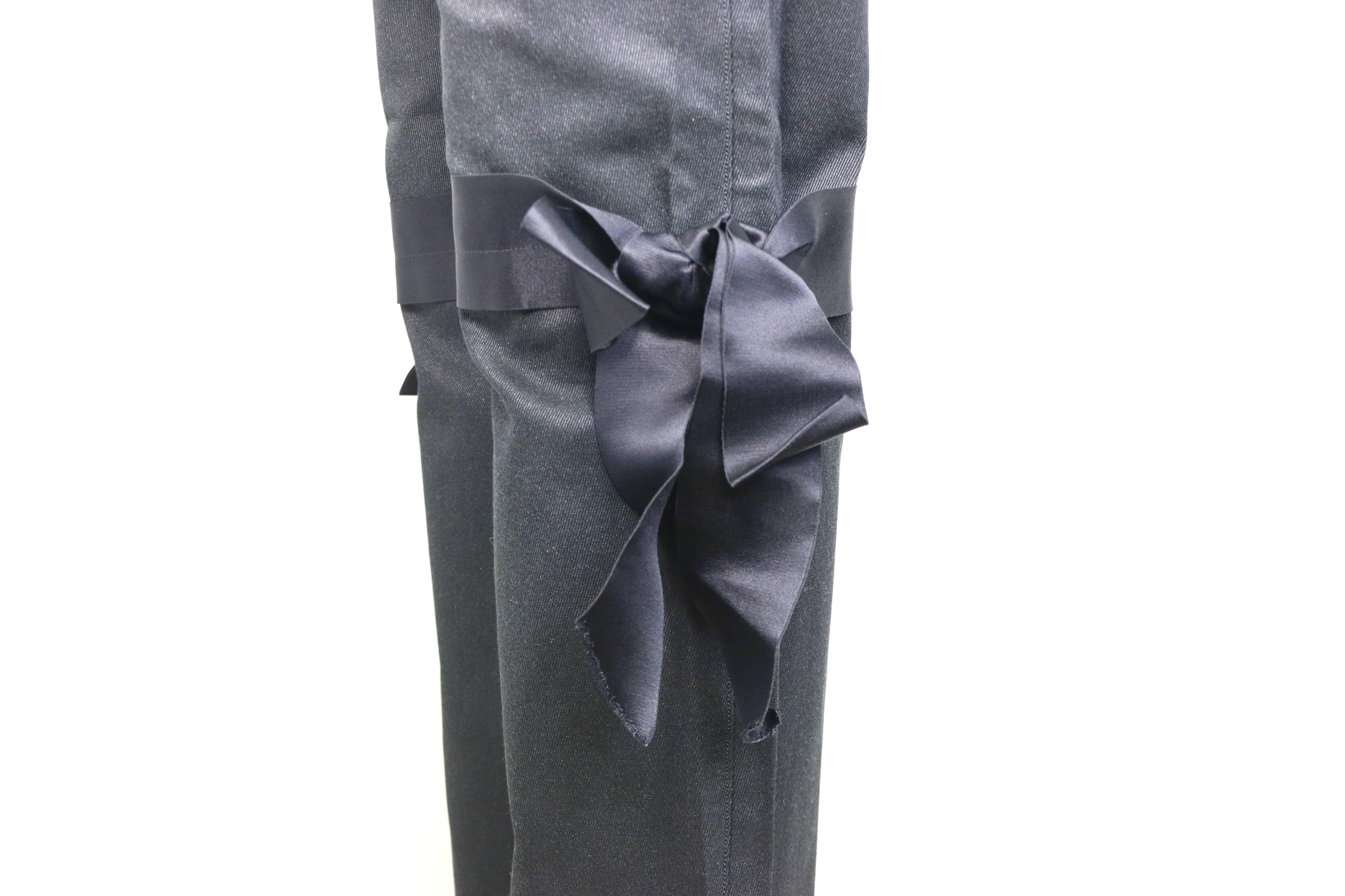 - Chanel black jeans with silk tied bows. 

- Silver stripe pattern. 

- Silk waist Trim with 