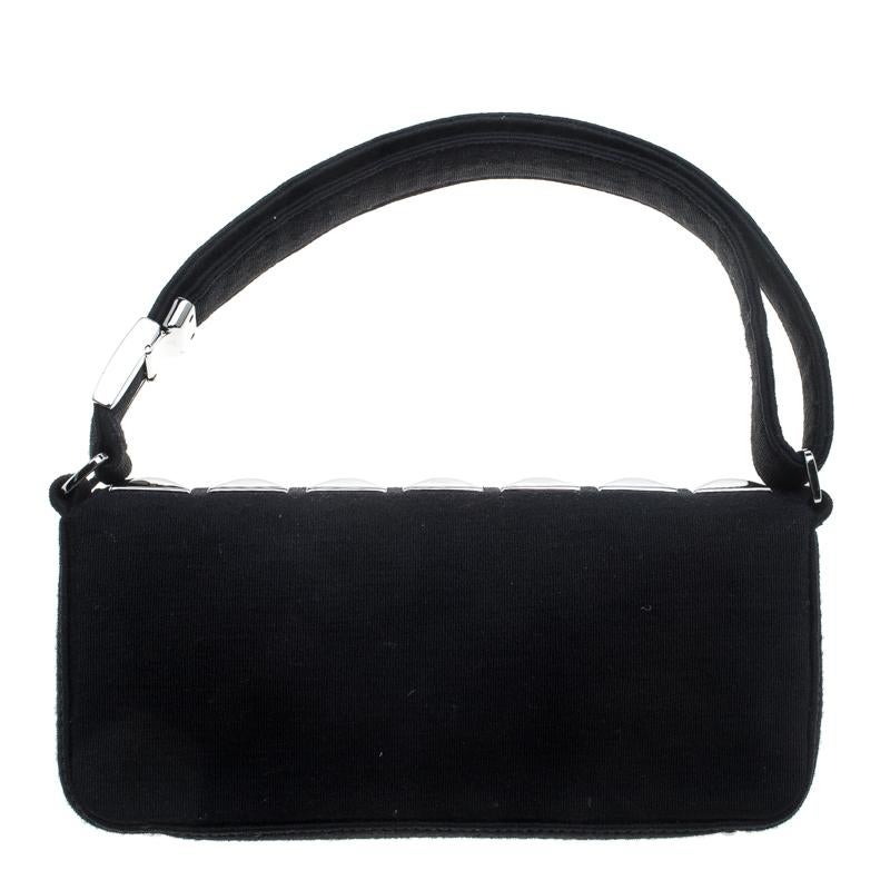 Add a winning touch to your evening attire with this stylish Chanel flap shoulder bag. It carries the same elegance and beauty as the label's other iconic bags; however, its eccentricity lies in its unique design. Crafted from black jersey fabric,