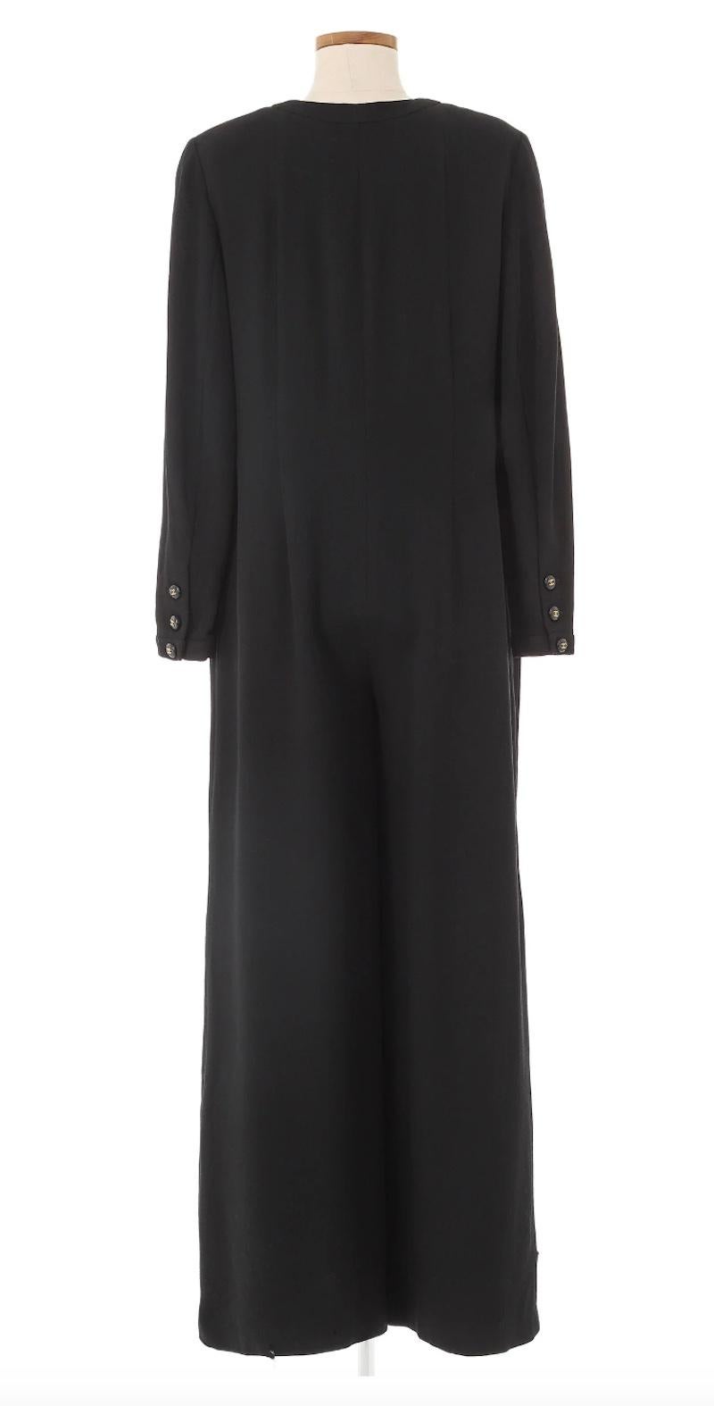 Chanel Black Jumpsuit likely from the Spring 1995 collection by Karl Lagerfeld. Sophisticated and tailored silhouette in a black wool material, with Chanel buttons along the front & pockets. Perfect piece for the fall/winter. Excellent Vintage