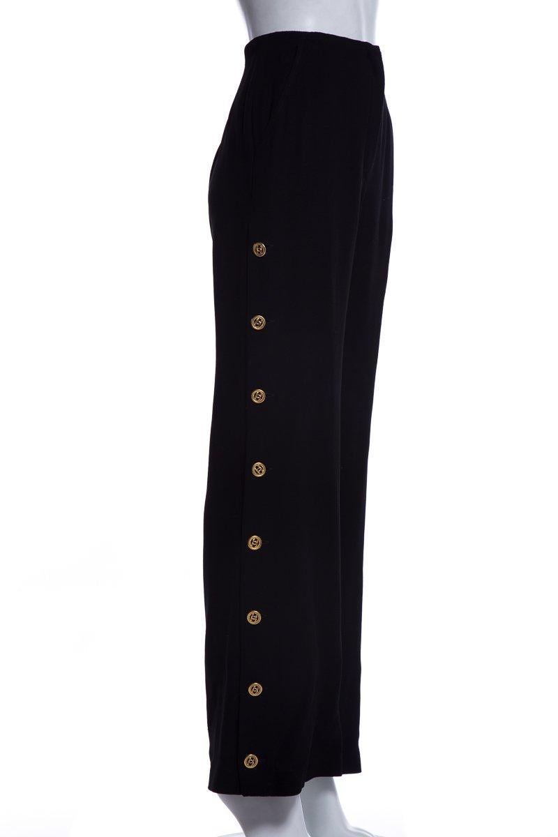 Chanel pants featuring dual slit pockets, gold-tone button accents featuring interlocking CC motifs at sides and zip closure at front.