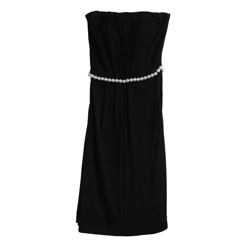 From the spring 2009 collection, this black strapless dress from the house of Chanel is cut to a floaty, knee-length silhouette that's full of movement. Secured with a concealed zip closure at side seam, it is adorned with fantasy pearl