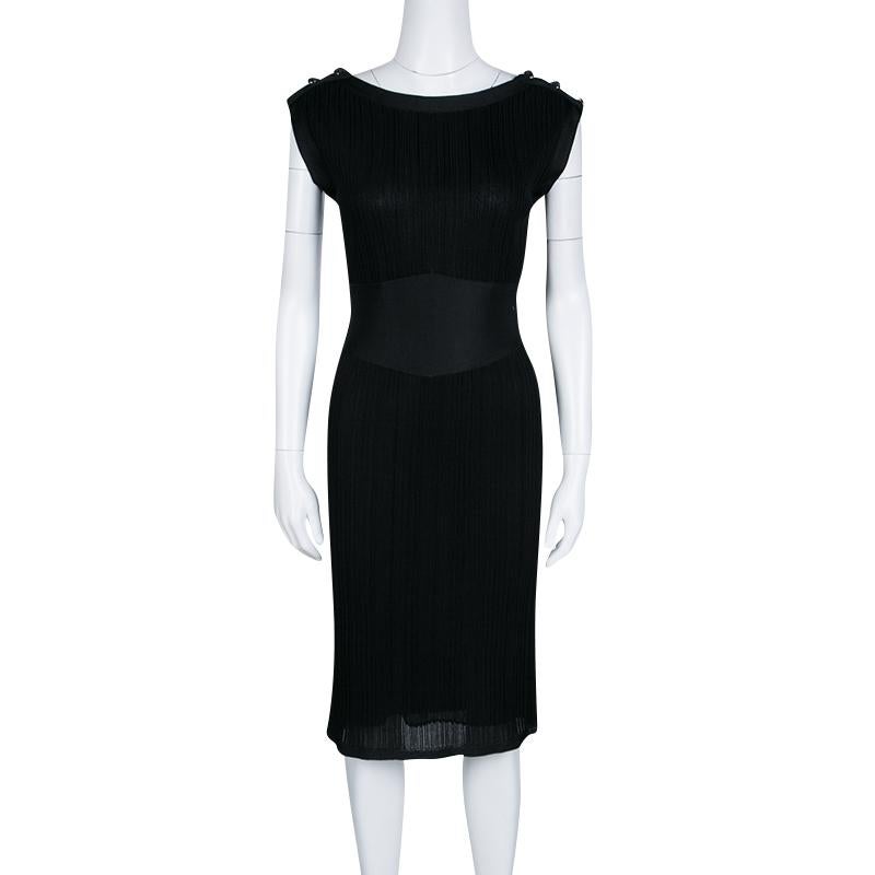 It is a classic black dress from Chanel that is cut to a slim silhouette. Ideal for parties and gatherings, the dress has a textured finish. It has fitted silk waistline and button details on the shoulders. This sleeveless dress will make you stand
