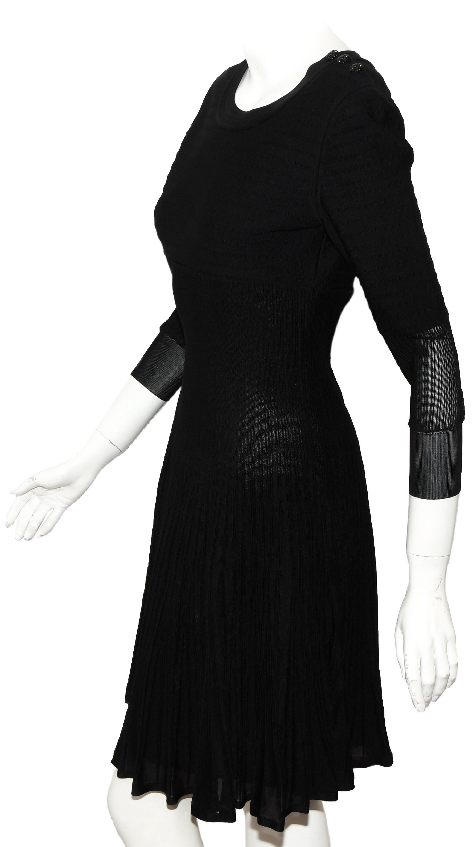 Chanel black knit silk blend dress from the 2009 cruise collection is a show stopper with stretch silk and viscose on the upper torso then transitioning to silk ribbed pleats and flaring to a full skirt.   The sleeves have the same composition as