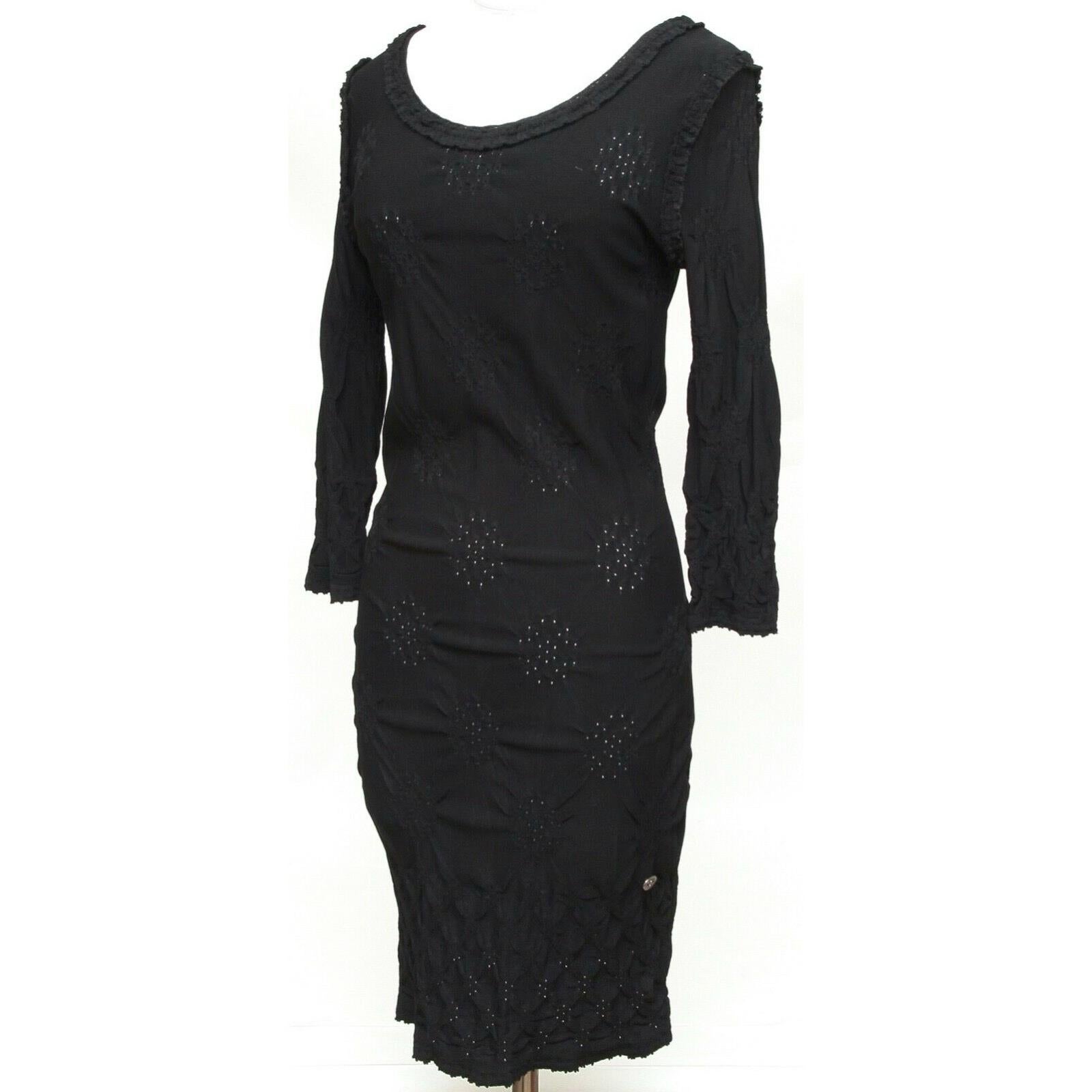 GUARANTEED AUTHENTIC CHANEL CRUISE 2011 BLACK POINTELLE KNIT DRESS

Design:
- Viscose blend pointelle knit long sleeve dress.
- Scoop neck.
- Silver-tone CC metal plaque at lower left hem.
- Unlined.

Material: 75% Viscose, 25% Polyamide

Size: