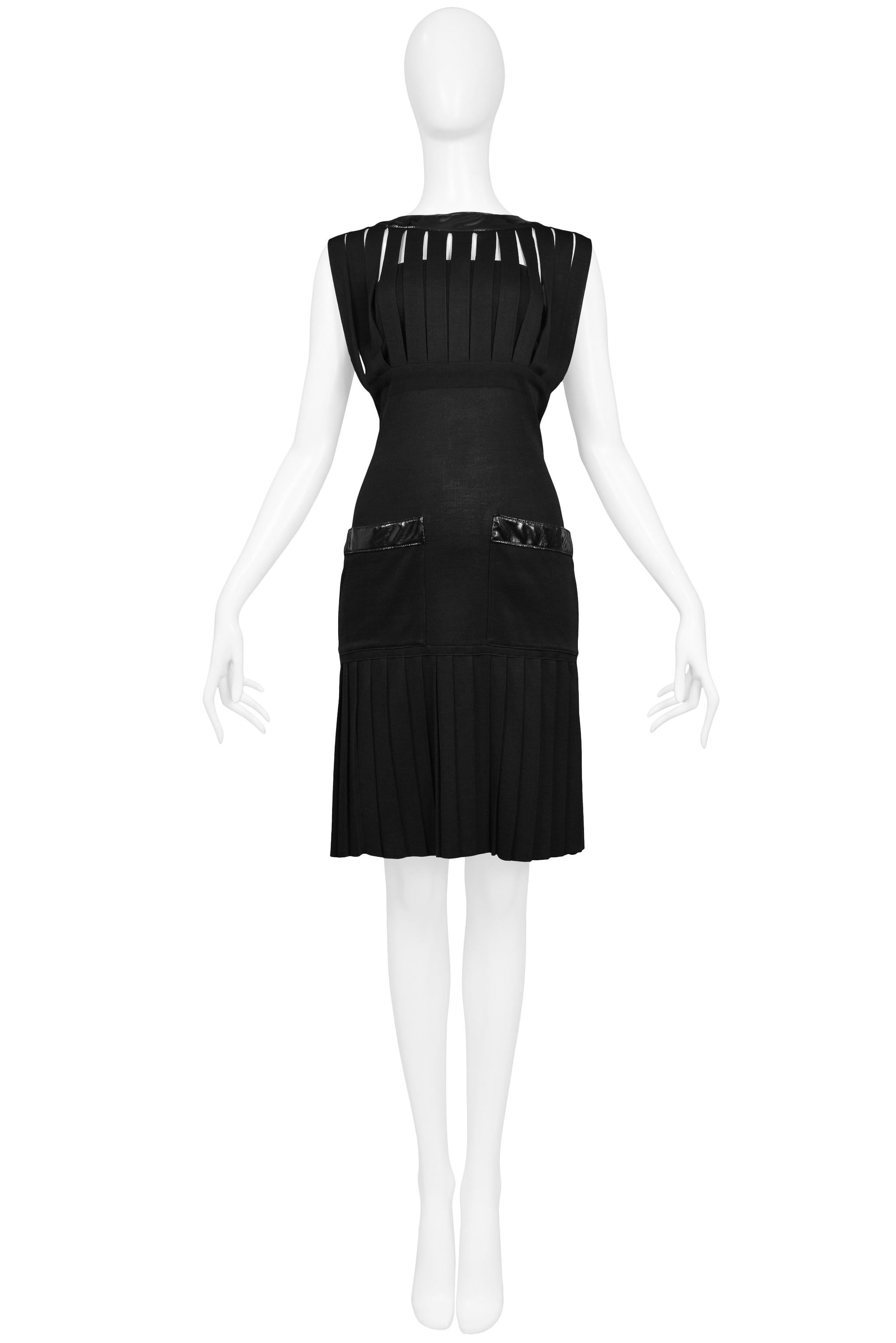 Resurrection Vintage is excited to offer a vintage Chanel black viscose knit cocktail cage dress featuring vertical bands, black wetlook trim, black and gold 