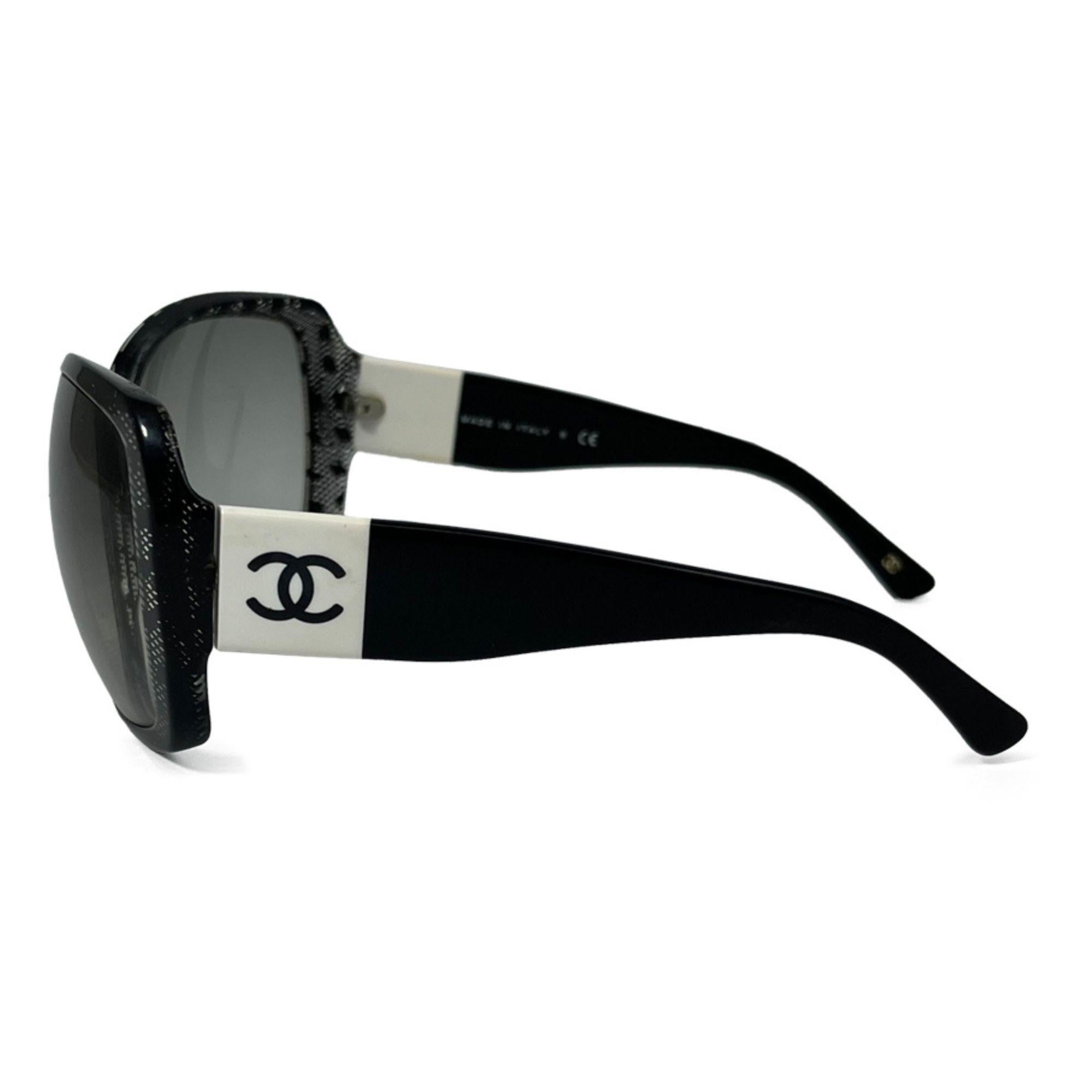 Chanel Lace CC Sunglasses Black 5145. Featuring black frames with large squared rims and lenses with a gradient gray. The arms are a medium width with a white band and a black Chanel CC logo.

Hardware: Acetate
Lens: Black
Size: 125/61/16
Lens