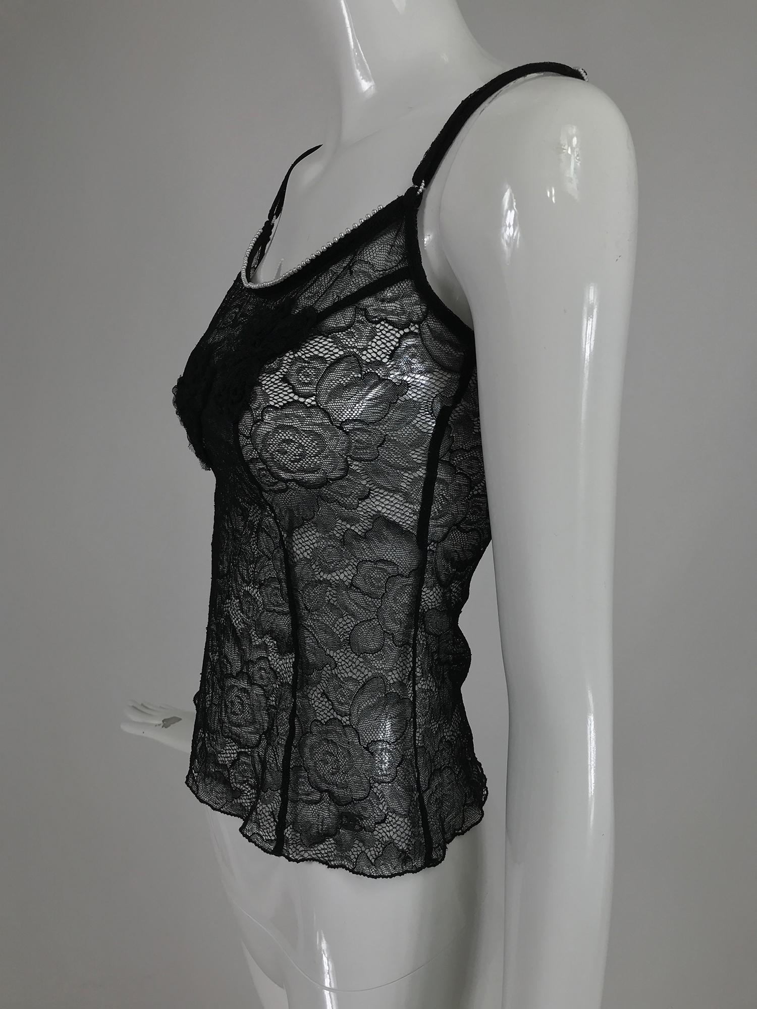 Chanel black lace, pearl trimmed, embroidered camisole 2004A. Black stretch lace camisole with embroidered black net ribbon flowers. Stretch lace with adjustable straps each with tiny pearl adjustments. Marked size 36, has stretch.
 In excellent