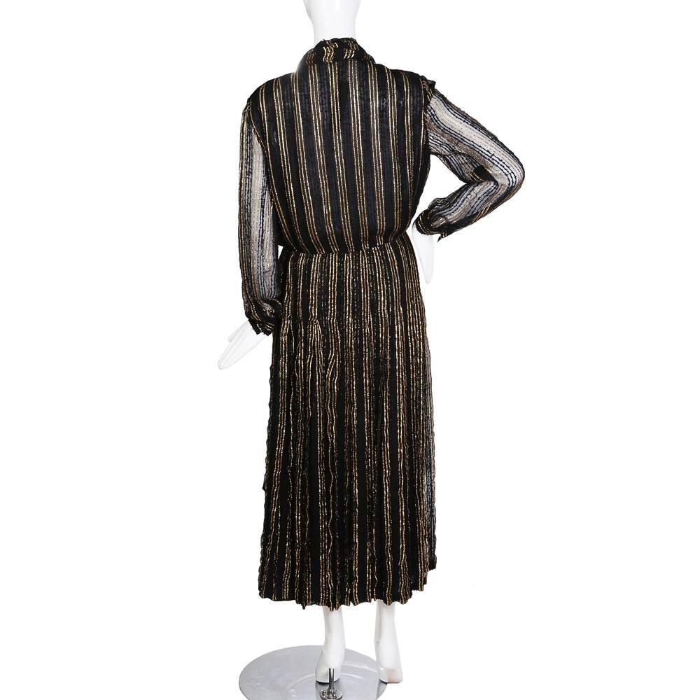 Dress from Chanel circa 1970s
Black embroidered mesh with metallic gold threading to create vertical stripes
Front buttons closure
Condition: Excellent vintage condition
Size/Measurements:
Size 12
17