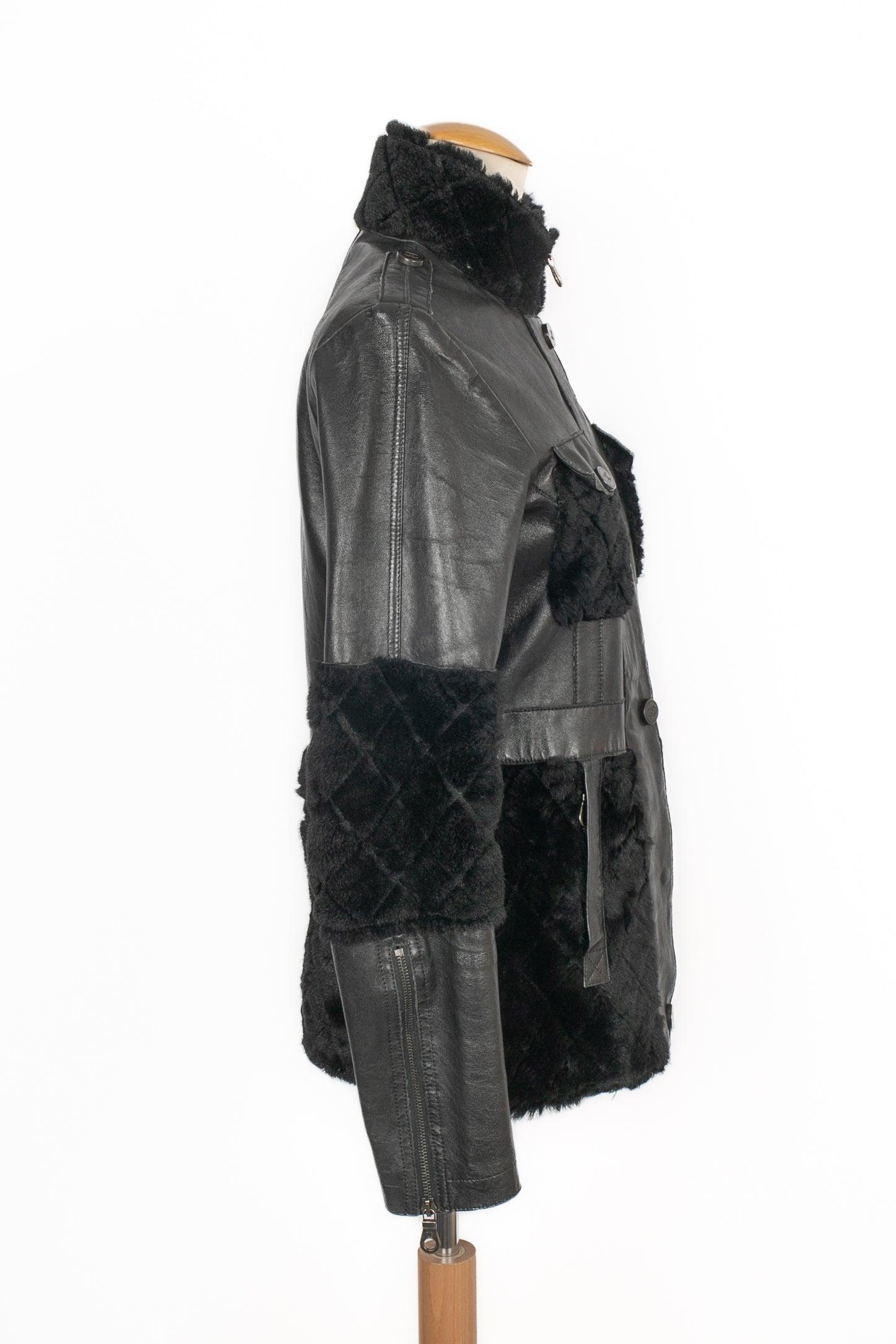 CHANEL - (Made in Italy) Black lamb leather jacket with quilted black wool, and with press studs decorated with cc logos. Size 36FR indicated. 2010 Fall-Winter Collection, under the artistic direction of Karl Lagerfeld.

Additional