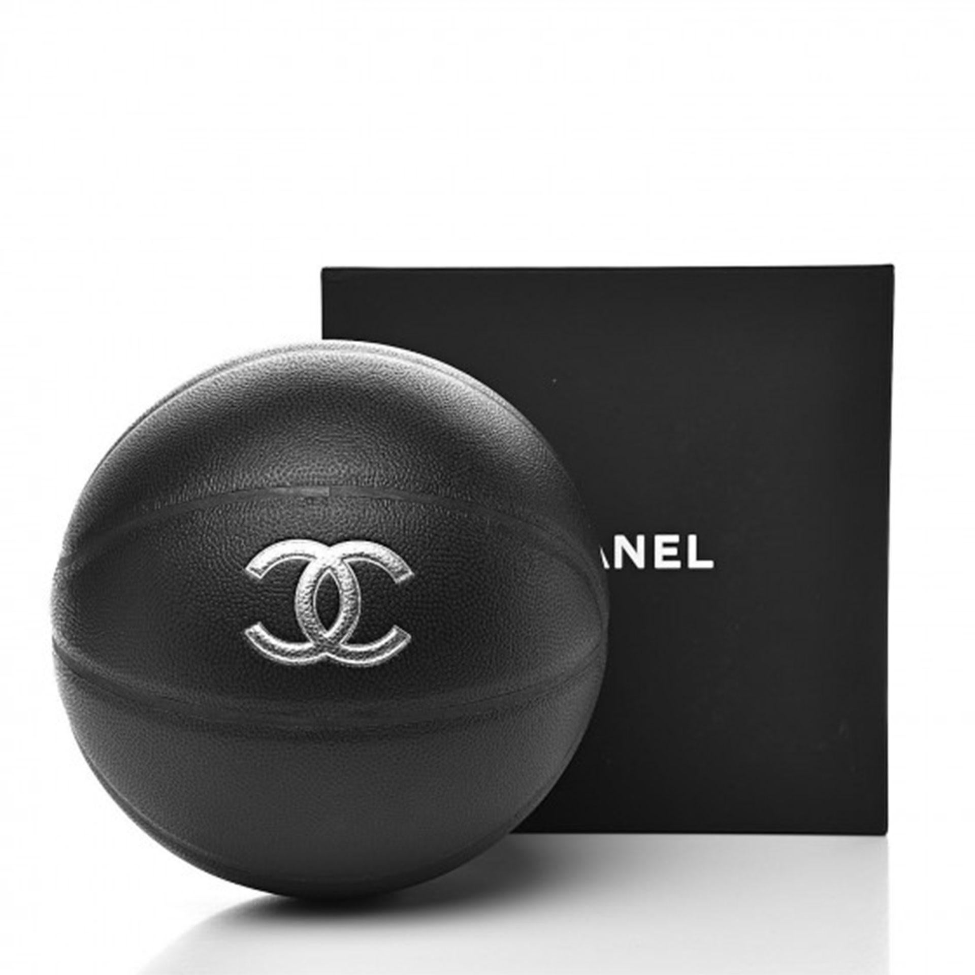 All-black designer basketball is regulation size, with silver Chanel and CC lettering, and includes a lambskin chain net with a strap. 