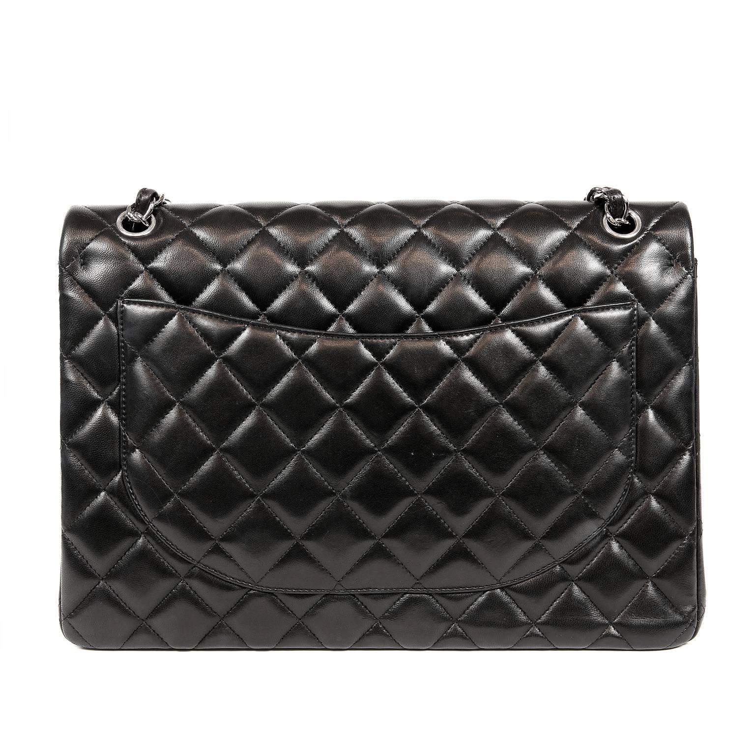 Chanel Black Lambskin Classic Maxi- MINT condition
The largest of the classics, the Maxi is a must have in any collection.
Black lambskin is quilted in signature Chanel diamond pattern.  Silver interlocking CC twist lock secures the exterior flap. 