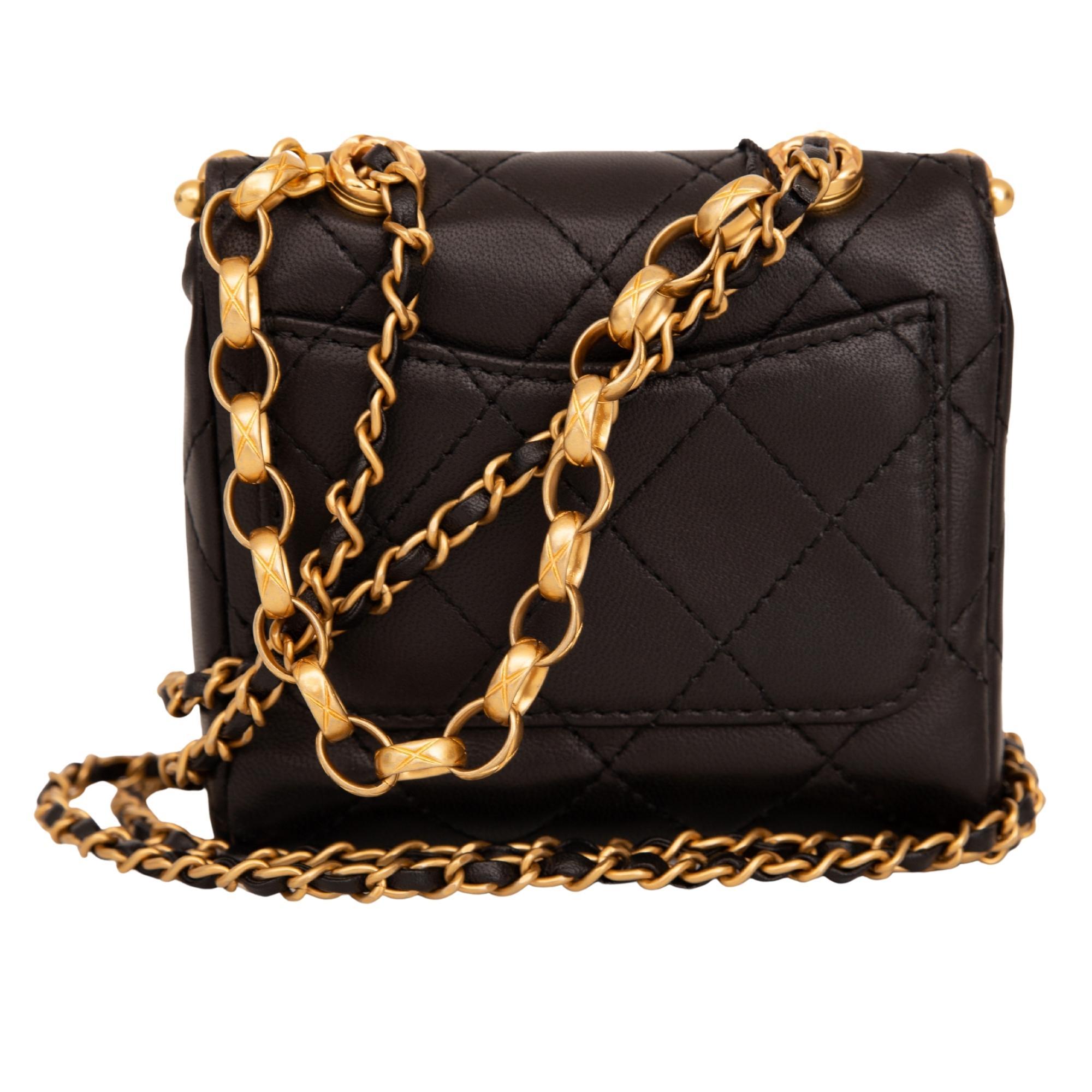 Chanel mini bag made of lambskin leather and features gold tone hardware, kiss lock closure, a gold tone chain interlaced with leather shoulder strap, a decorative gold tone chain at front and beige leather interior lining. Chanel bags with the