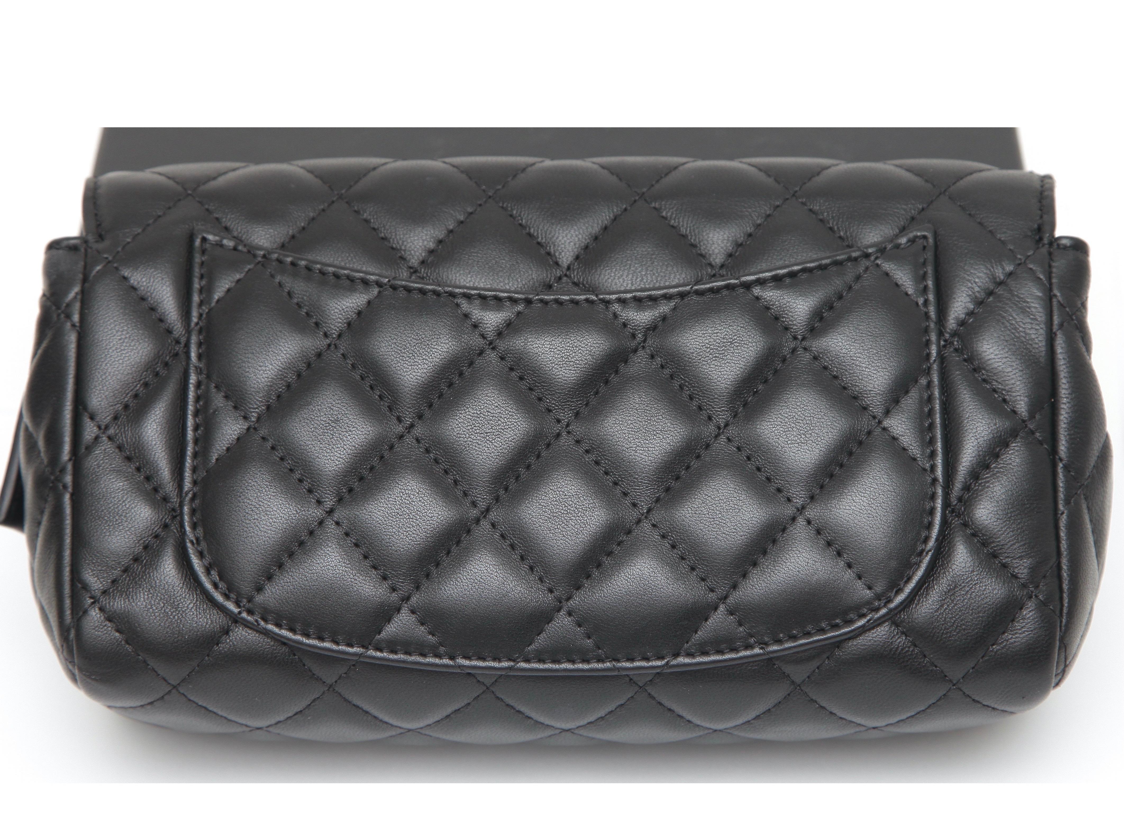 GUARANTEED AUTHENTIC CHANEL 13C BLACK LAMBSKIN QUILTED O-COIN CASE

Details:
- Black lambskin quilted leather.
- Can be used for cosmetics and/or daily items.
- Front flap.
- Silver-tone CC logo at front.
- Snap closure.
- Interior lined in burgundy