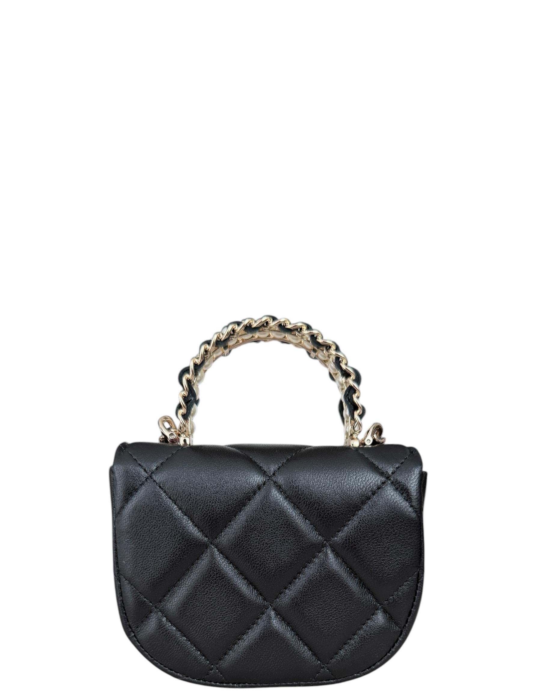 Chanel Black Lambskin Leather Quilted Pearl Top Handle Clutch Crossbody w/ Chain

Made In: France
Color: Black
Hardware: Goldtone
Materials: Lambskin leather
Lining: Grosgrain 
Closure/Opening: Top flap with magnet
Exterior Condition: Excellent,