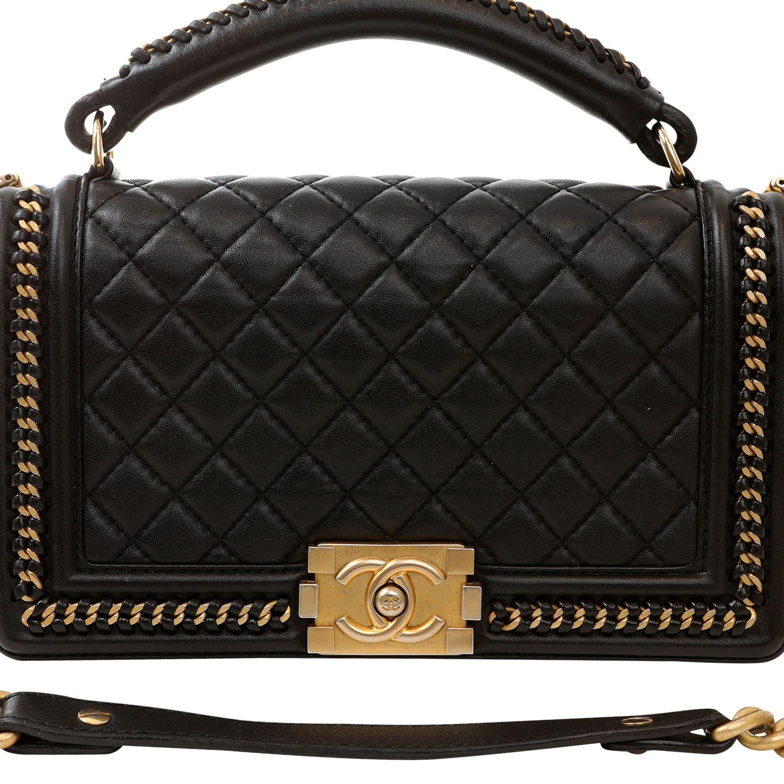 This authentic Chanel Black Lambskin Medium Chain Around Boy Bag is in pristine condition. The updated design is structured and edgy with a versatility that makes it extremely popular.  Black lambskin is quilted in signature Chanel diamond stitched