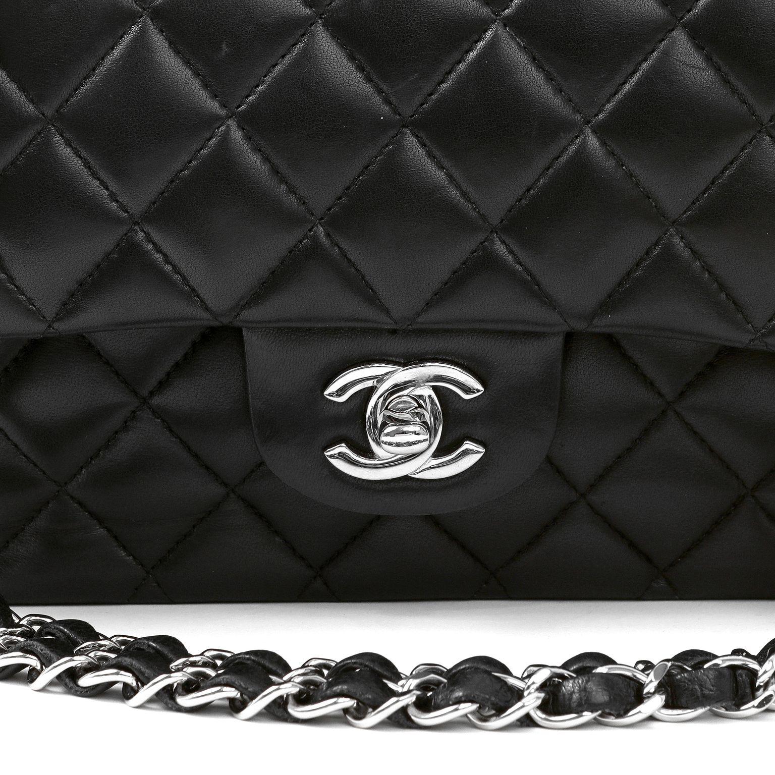 This authentic Chanel Black Lambskin Medium Classic Flap Bag is in pristine condition.  A key piece in any sophisticated wardrobe, the Classic Flap is one of the most sought-after Chanel styles produced.

Smooth lambskin is quilted in signature