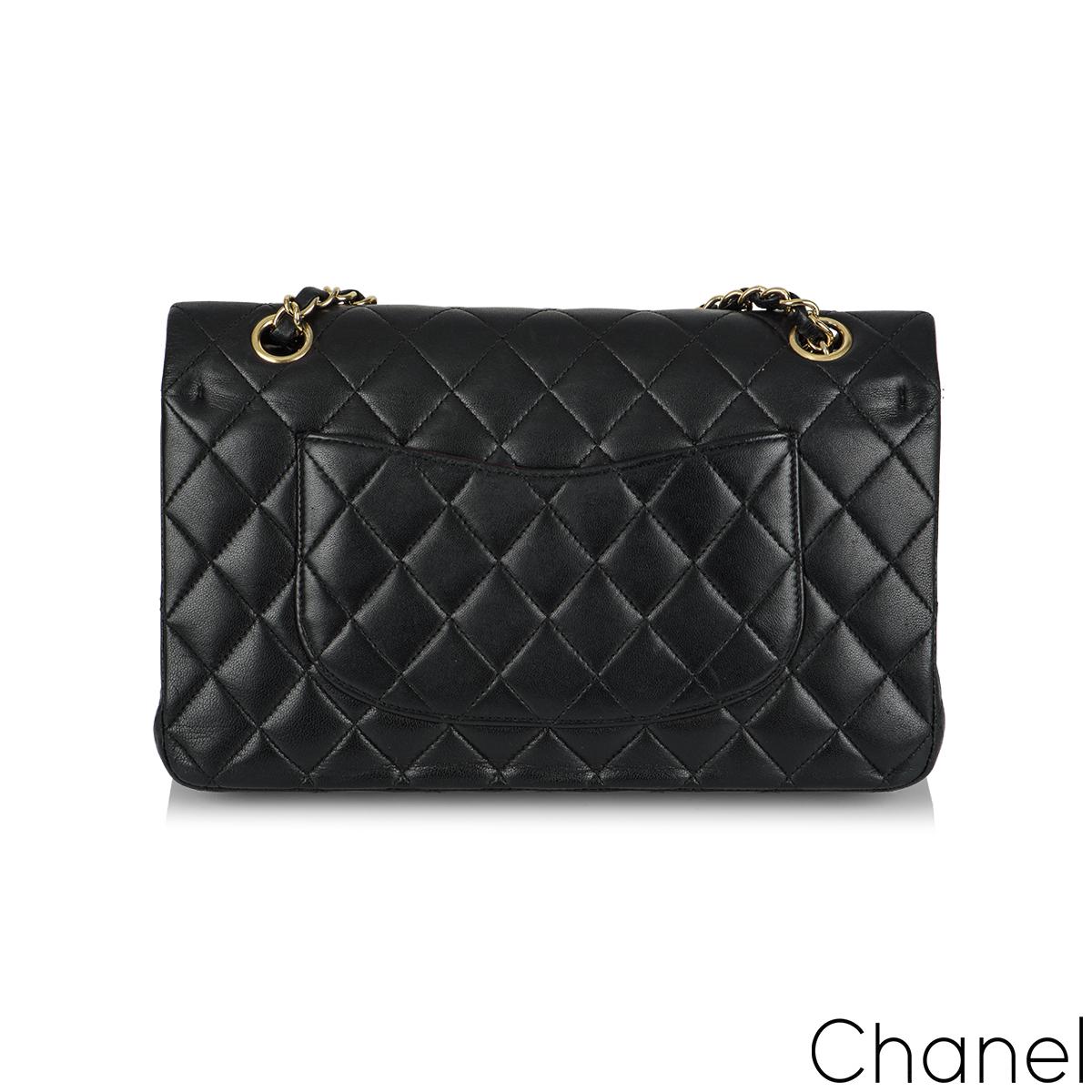 A Timeless Chanel Classic Double Flap Handbag. The exterior of this medium classic is in black lambskin leather with gold tone hardware. It features a front flap with signature CC turnlock closure, half moon back pocket, and adjustable interwoven