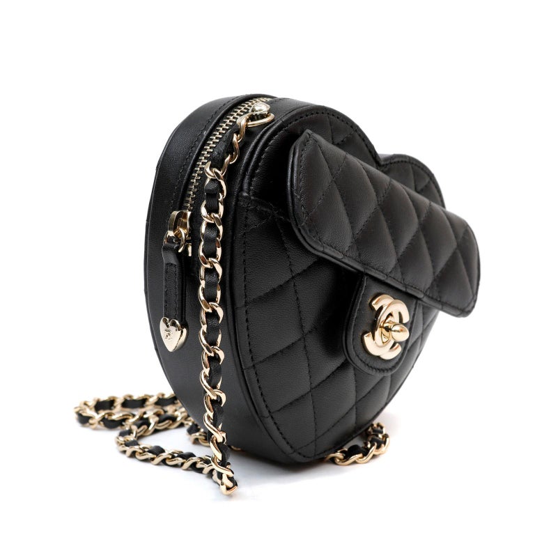 This authentic Chanel Black Lambskin Mini Heart Bag is in pristine unworn condition form the 2022 collection.  Completely SOLD OUT everywhere.  Heart shaped black lambskin mini bag is quilted in signature Chanel diamond pattern.  Front flap pocket