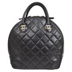 CHANEL Borsa da viaggio in pelle d'agnello nera trapuntata oro argento con manico superiore