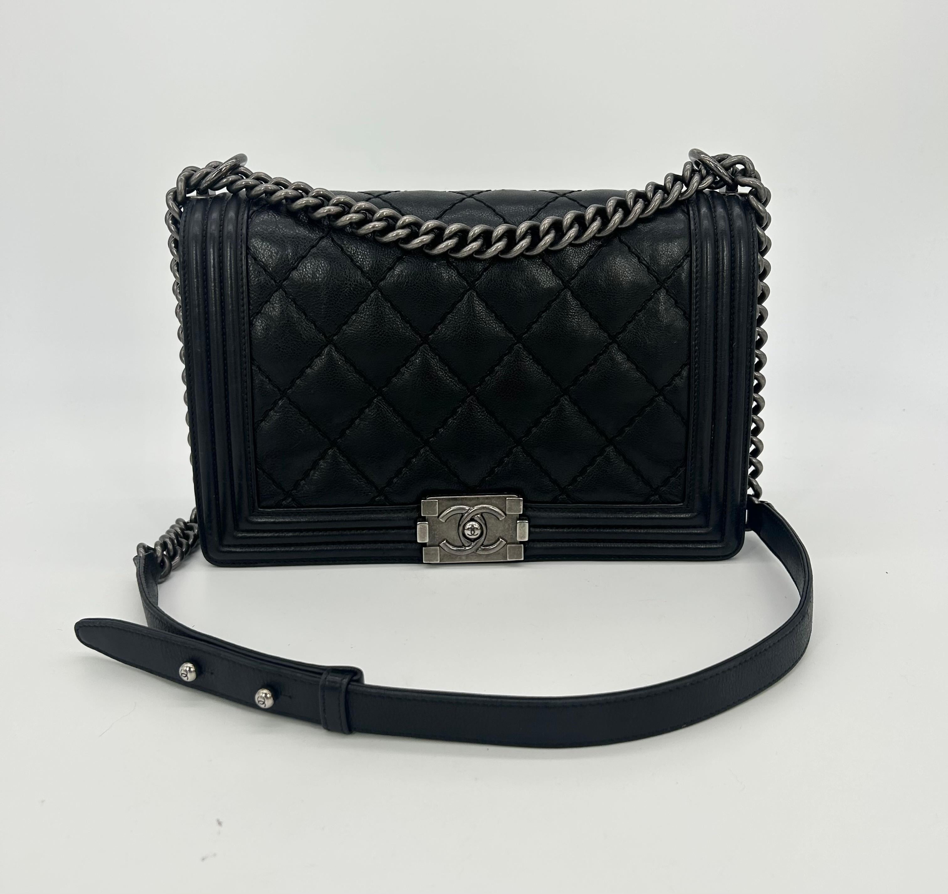 Chanel Black Lambskin Quilted Medium Boy Bag In very good condition. Black quilted lambskin exterior with black solid leather border along front and back sides. Antiqued Silver ruthenium hardware. Chain and leather shoulder strap can be worn short
