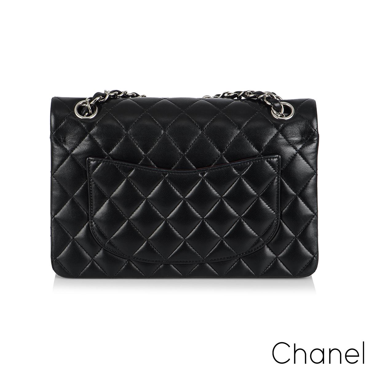 A Chic And Timeless Classic Chanel Double Flap Handbag. The exterior of this small classic is crafted with black lambskin leather with silver tone hardware. The small flap is designed with the signature diamond style stitching. It features a front