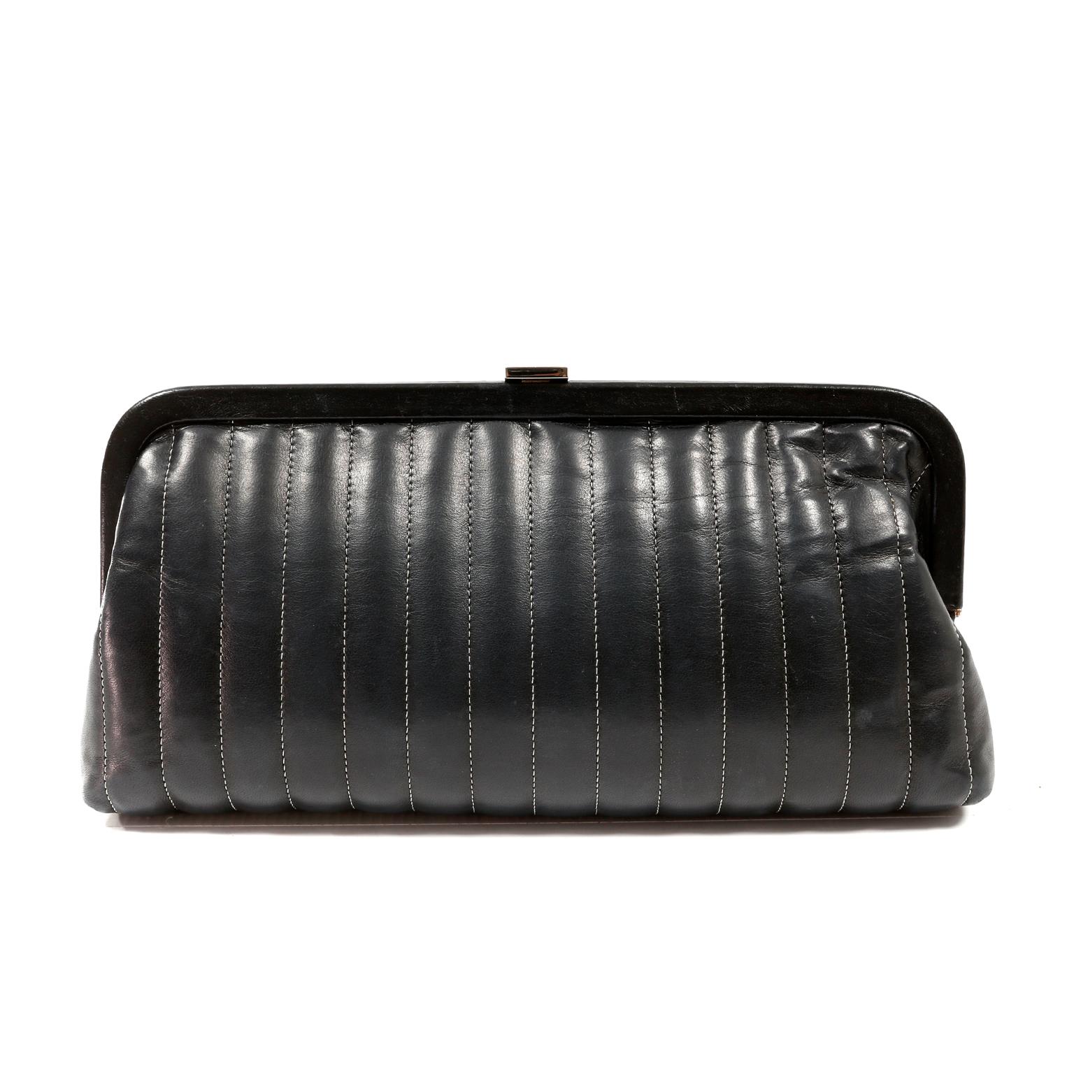 This authentic Chanel Black Lambskin Vertical Stitch Clutch is in good previously owned condition.  Elegant and timeless, this perfectly sized clutch is a great investment piece for a classic wardrobe.  
Soft black lambskin framed clutch is