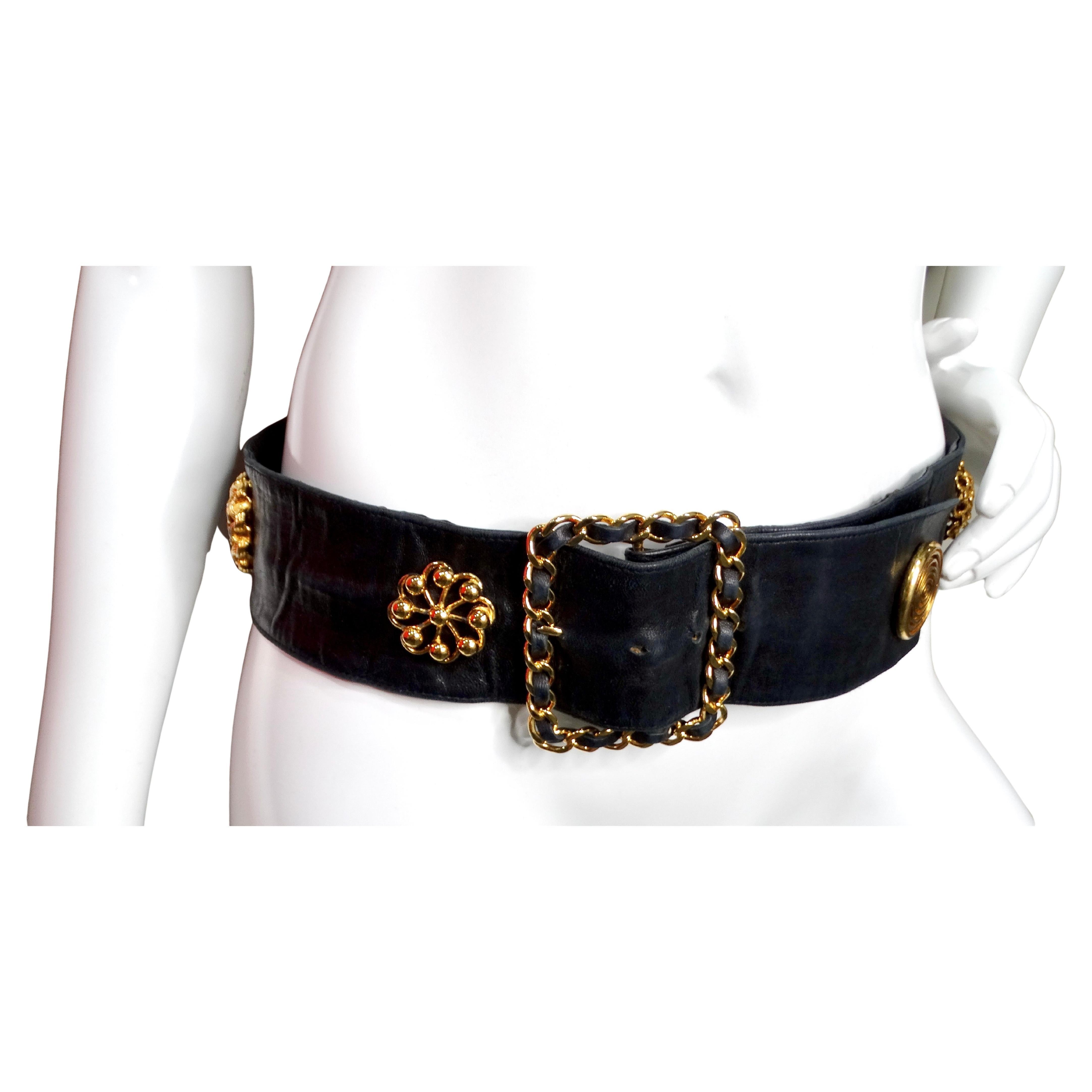 La cintura Chanel in pelle d'agnello nera Victoire de Castellane Gold-Tone, risalente agli anni '80, è un accessorio straordinario che incarna la lussuosa maestria e l'eleganza senza tempo associate a Chanel. Realizzata in morbida pelle d'agnello
