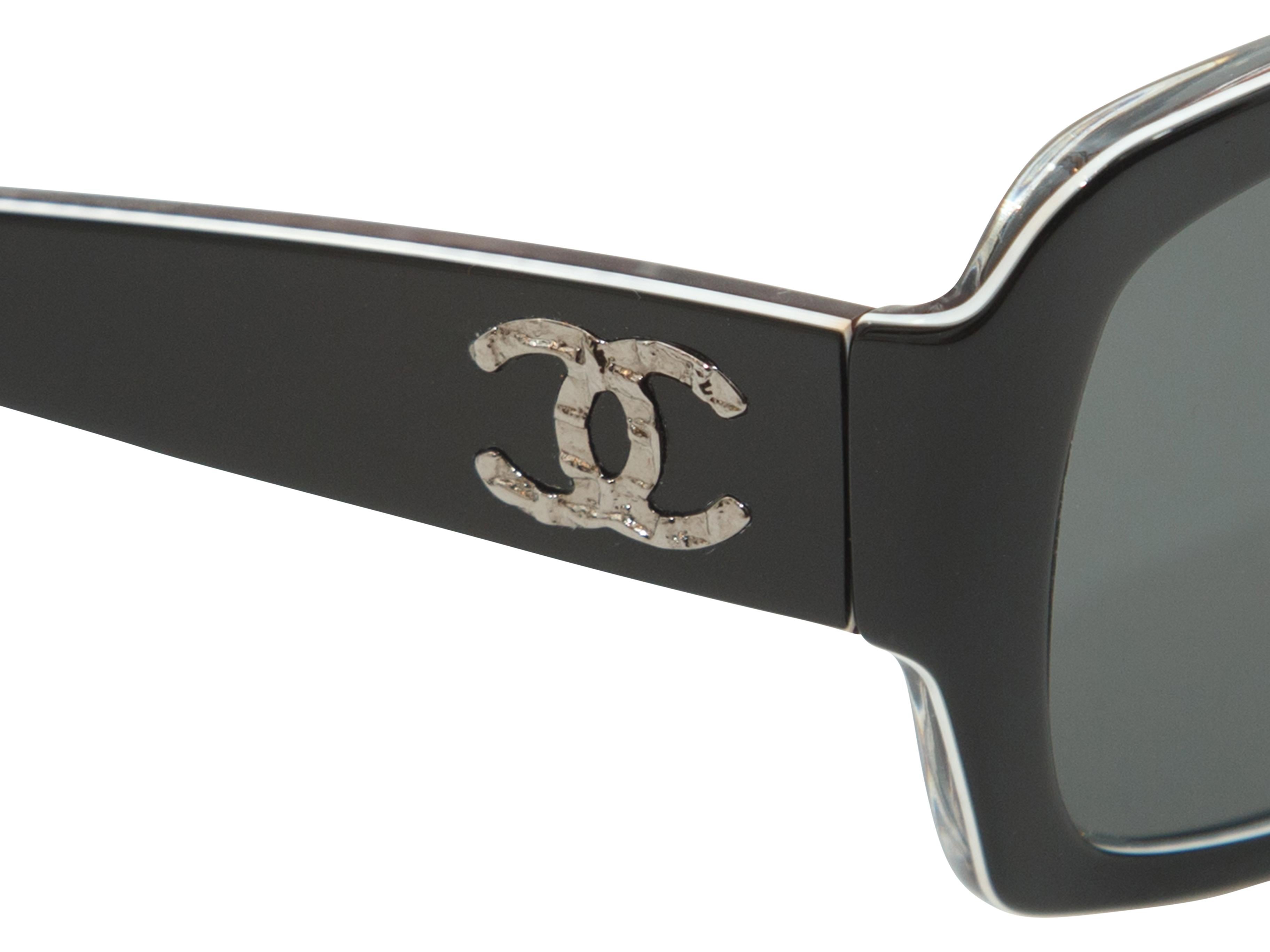 Product details: Black Large Chanel Sunglasses. The large-framed sunnies have black lenses, are trimmed in white, and have the crossed C — Chanel logo in silver on the temples. These sunnies come with their original case.   Measurements: 5
