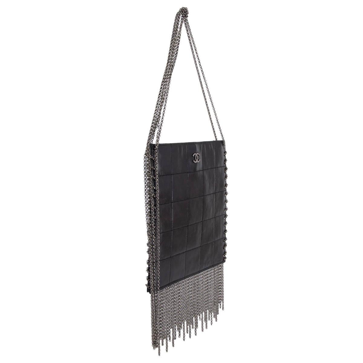100% authentic Chanel 2002 quilted chain fringe square shoulder bag in black smooth lambskin featuring gunmetal chain details. Opens with a magnetic button on top and is lined in black logo nylon with an open pocket against the back. Has been